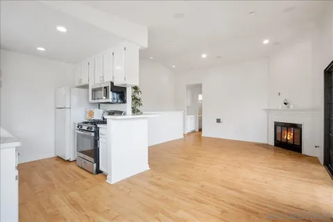 a view of a kitchen with a sink stove and cabinets