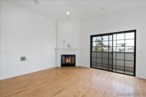 a view of an empty room with a fireplace and a window