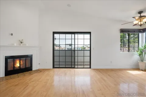 an empty room with a fireplace and window
