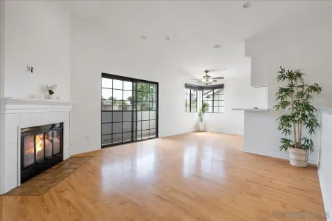 a view of an empty room with a window and fireplace