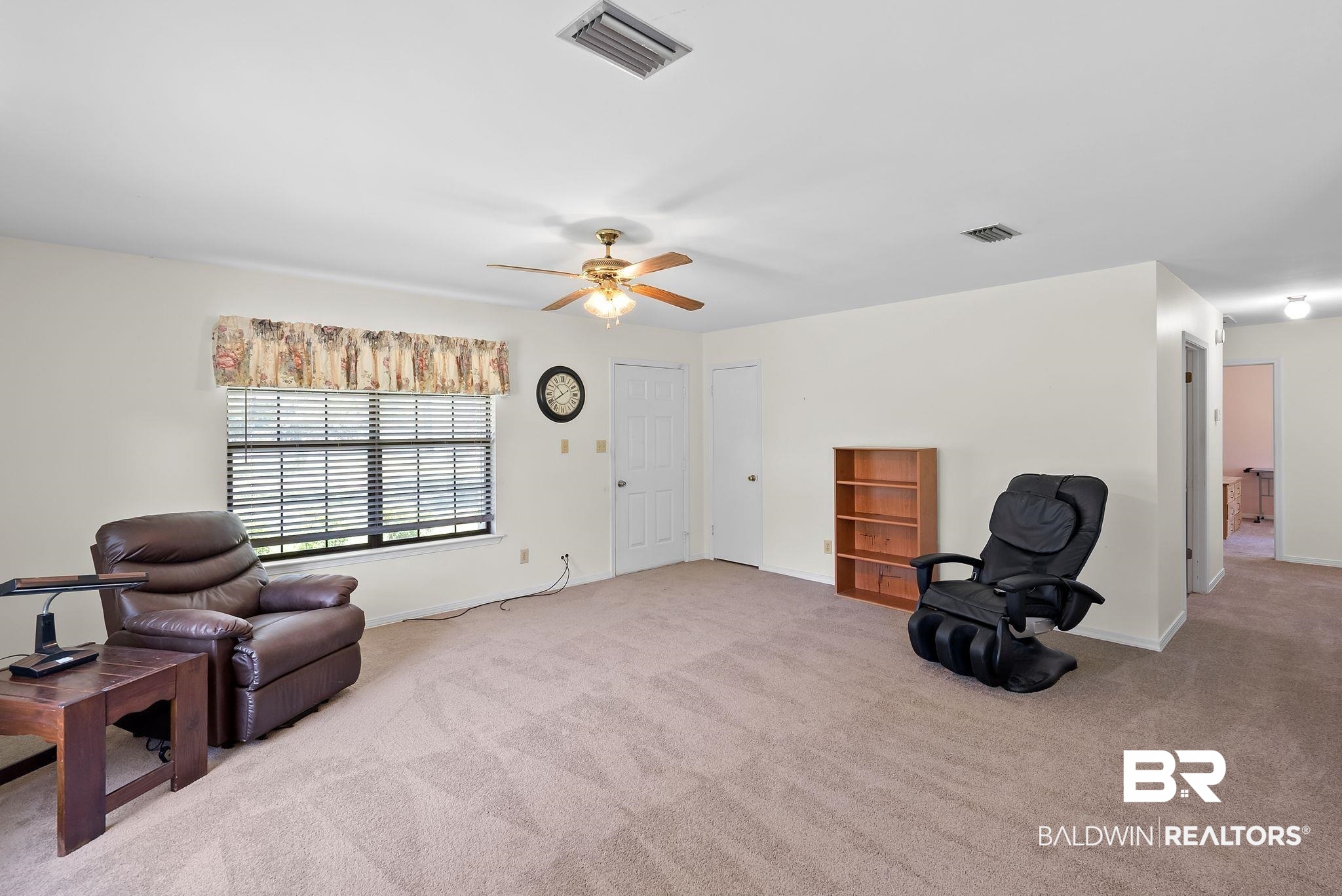 20540 Lacey Road Silverhill, AL 36576 - Photo 5 of 40 Spacious room featuring neutral carpet flooring, white painted walls, and a ceiling fan with integrated lighting