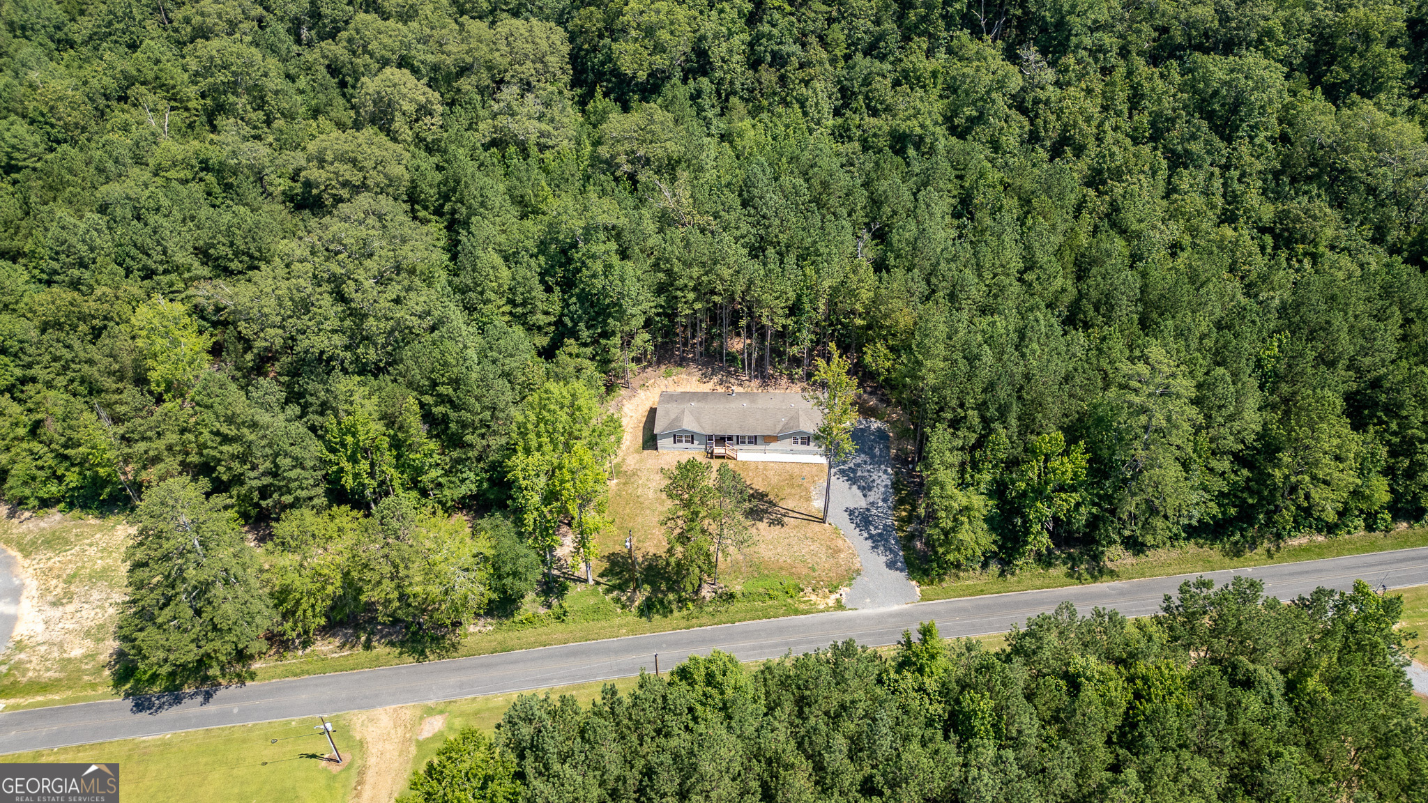 an aerial view of a house with a yard