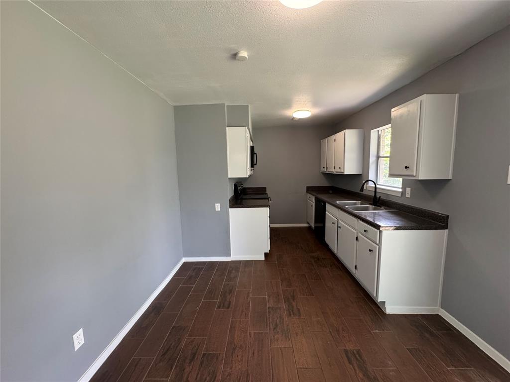 1913 Williamsburg Drive Plano, TX 75074 - Photo 1 of 1 a kitchen with granite countertop a stove a sink and a refrigerator