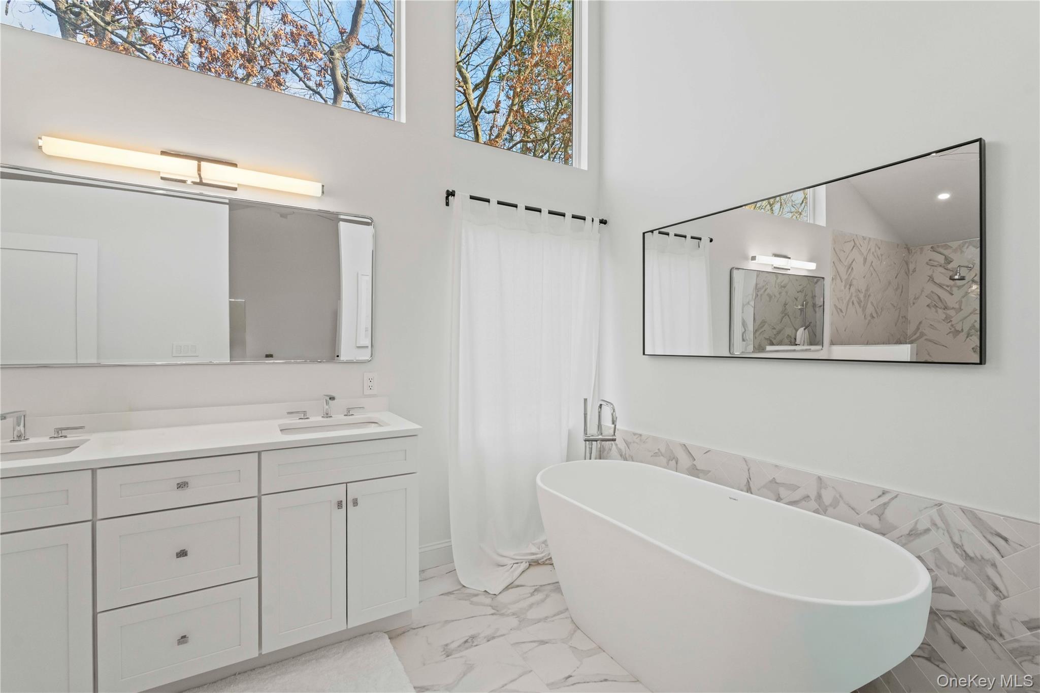 7 Midhampton Court Quogue, NY 11959 - Photo 14 of 29 a bathroom with a bathtub shower sink and mirror