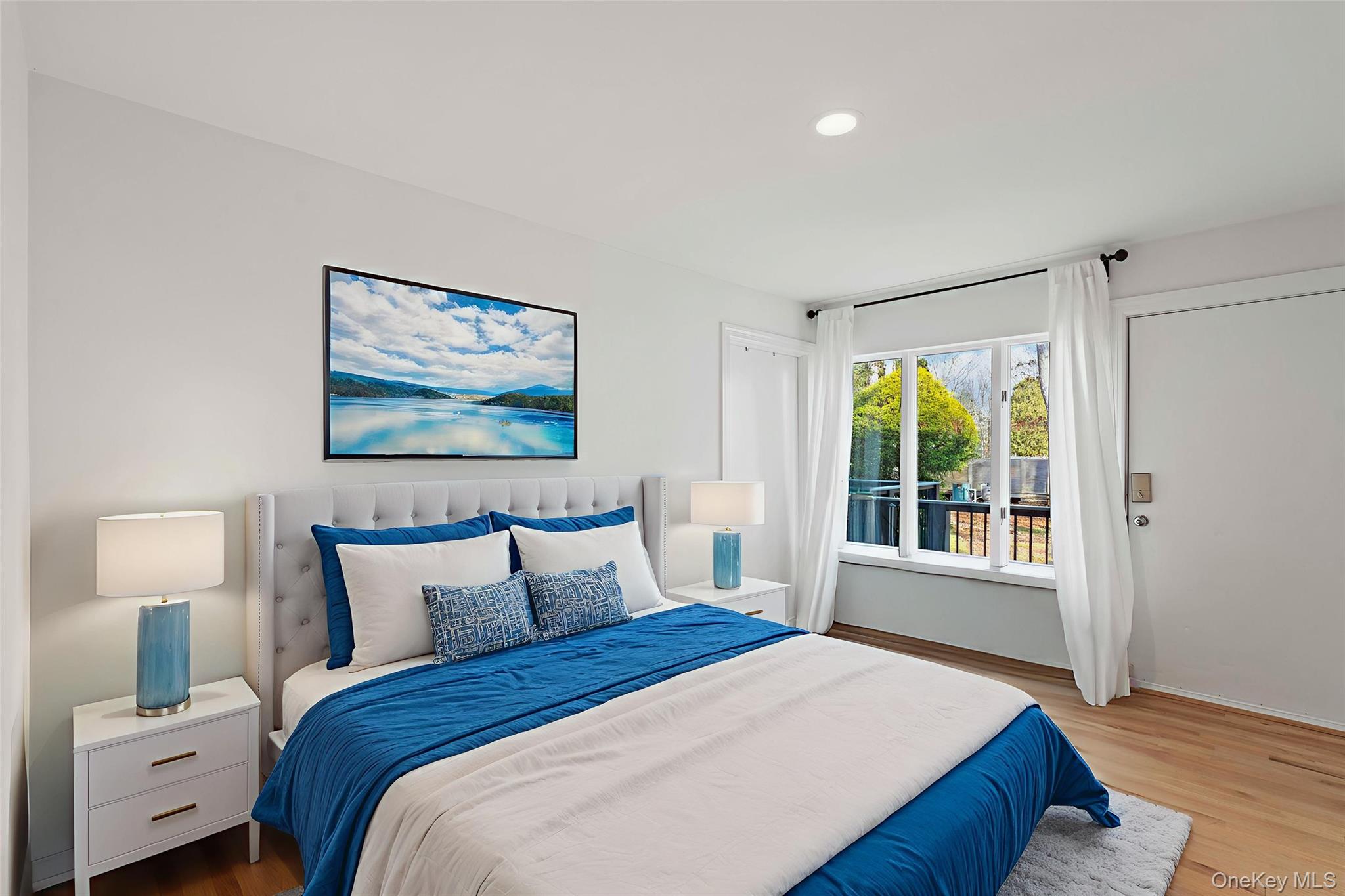 7 Midhampton Court Quogue, NY 11959 - Photo 15 of 29 a bedroom with a bed and window