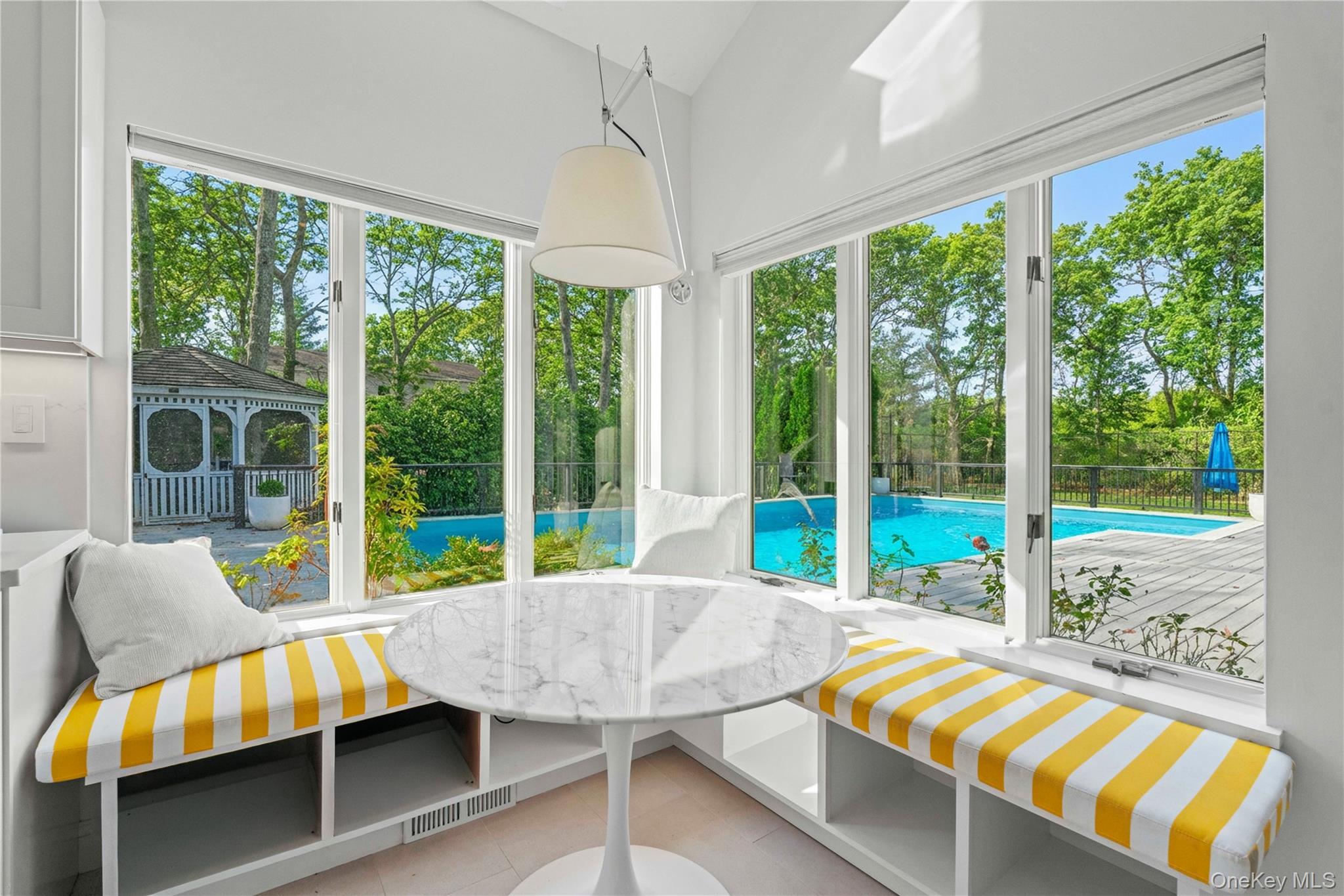 7 Midhampton Court Quogue, NY 11959 - Photo 17 of 29 a view of a room with a table and chairs