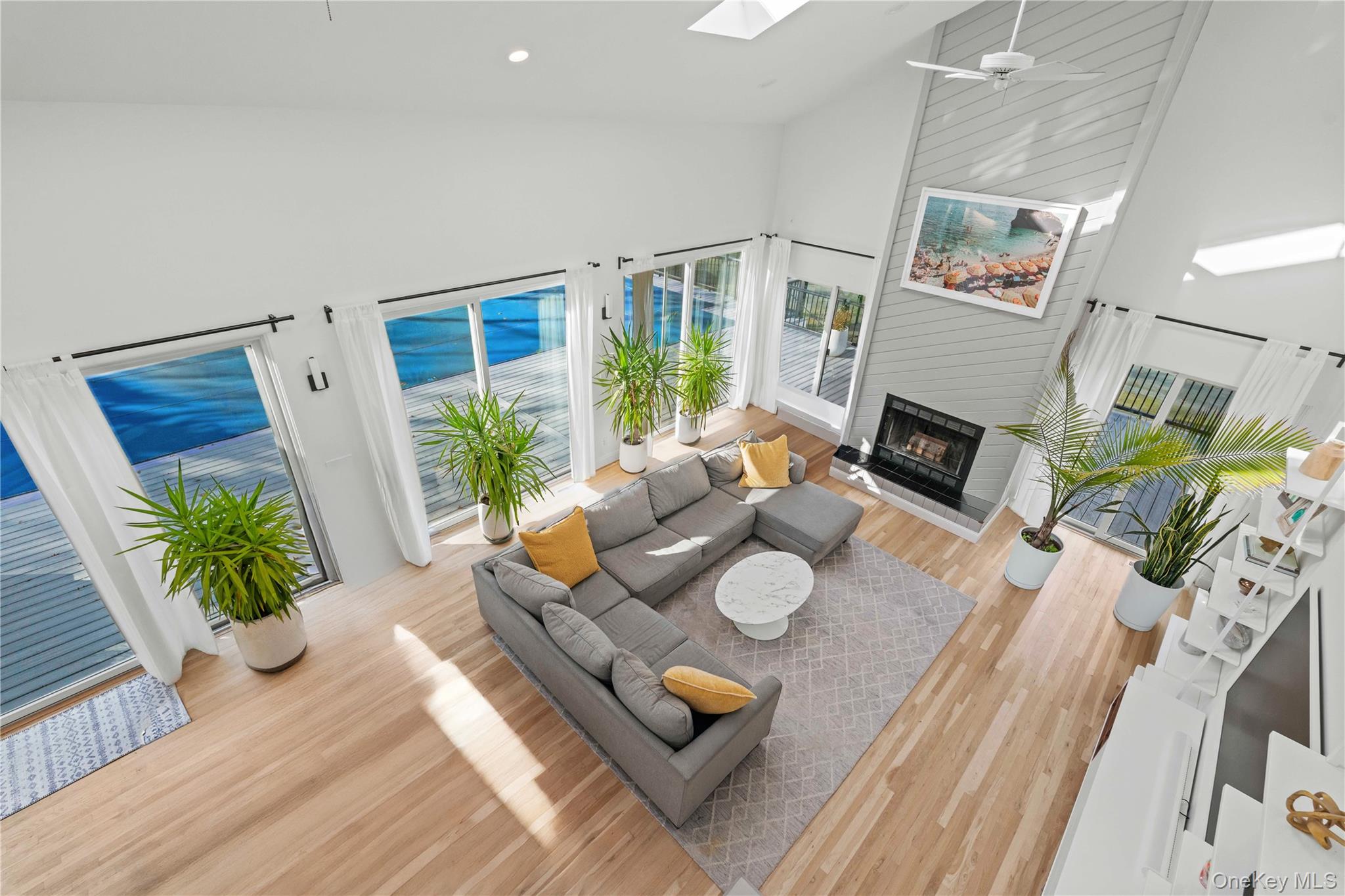 7 Midhampton Court Quogue, NY 11959 - Photo 19 of 29 a living room with furniture fireplace and a flat screen tv