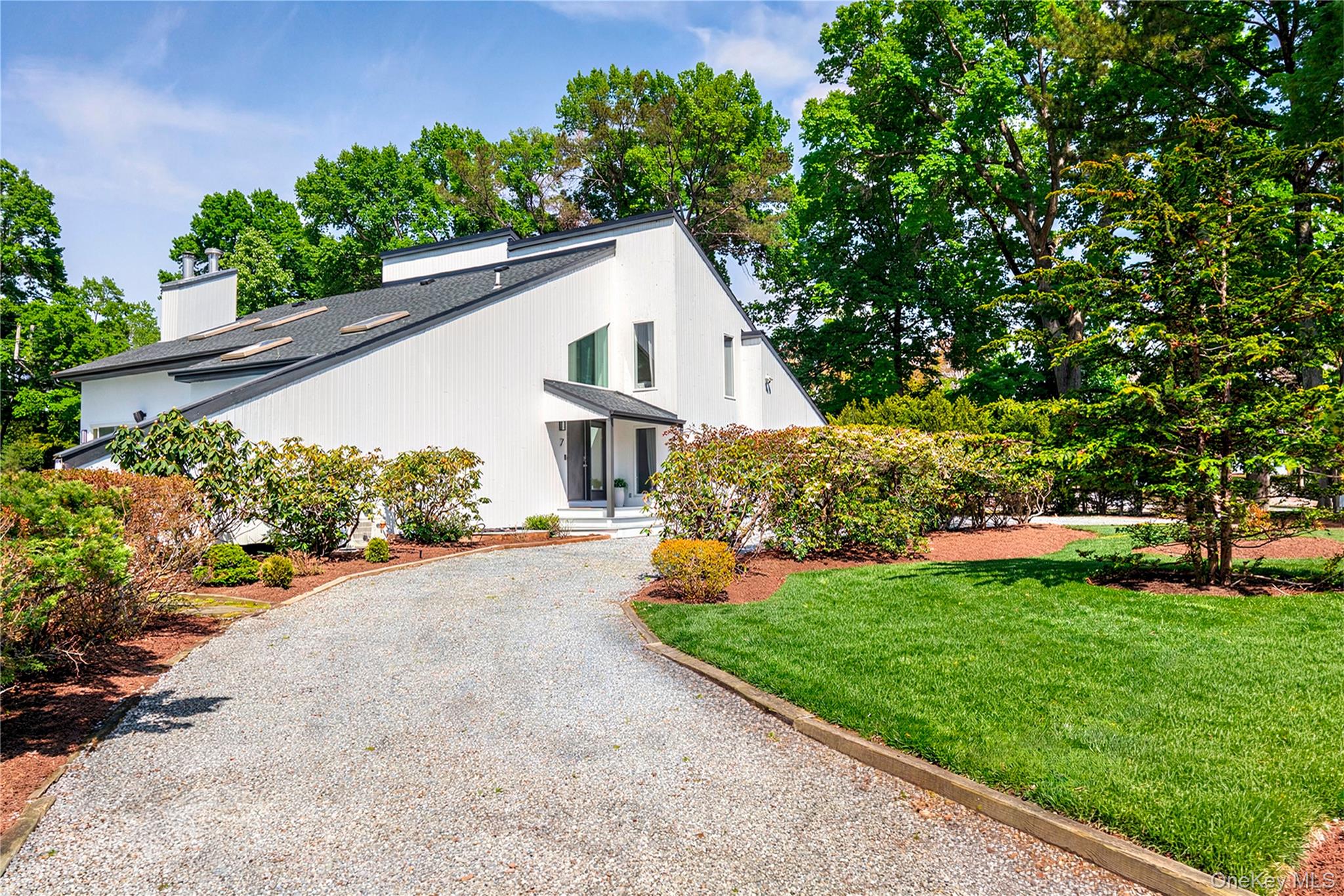 7 Midhampton Court Quogue, NY 11959 - Photo 2 of 29 a house view with a garden space