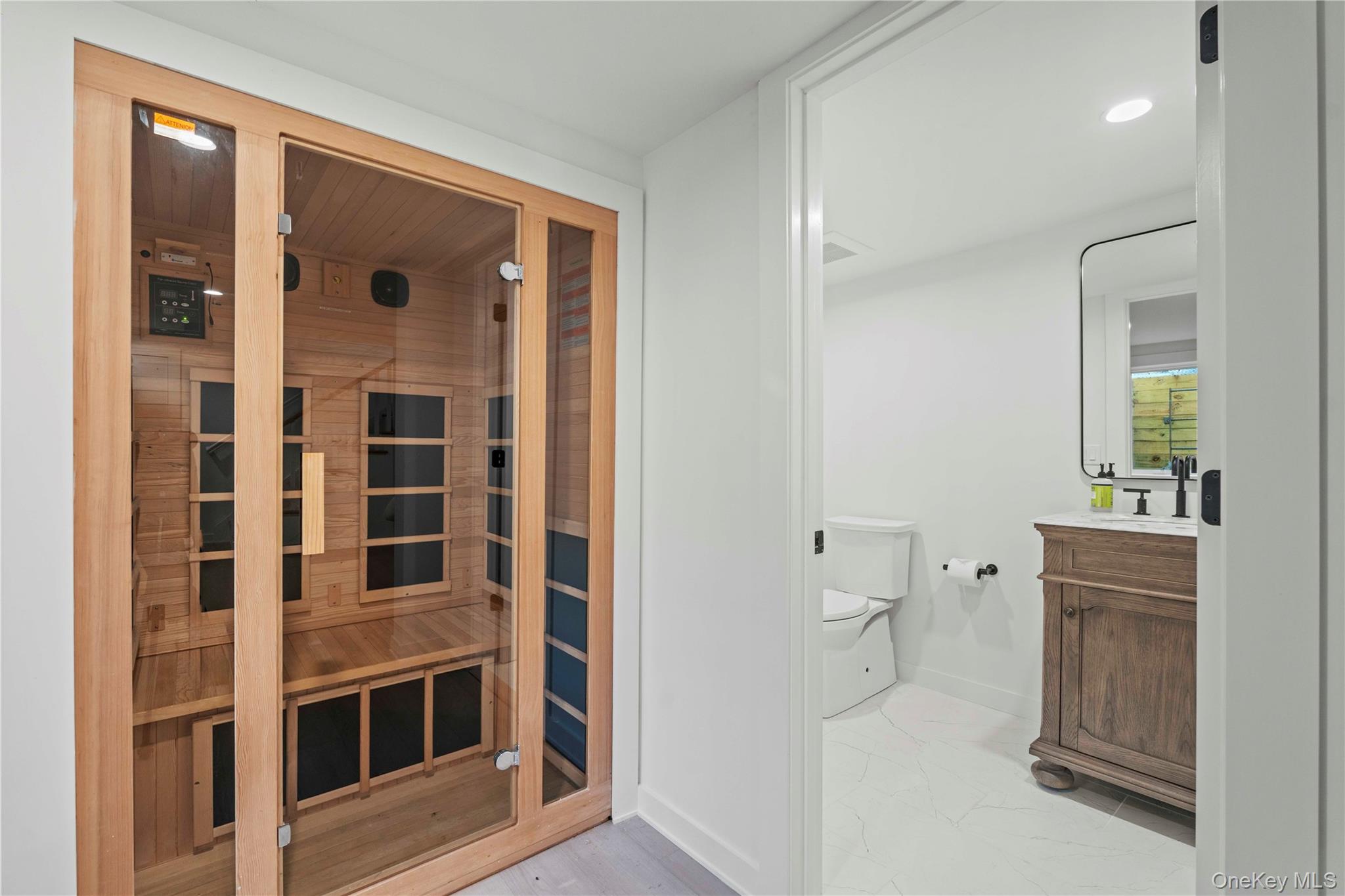 7 Midhampton Court Quogue, NY 11959 - Photo 25 of 29 a view of bathroom with a toilet sink and a mirror