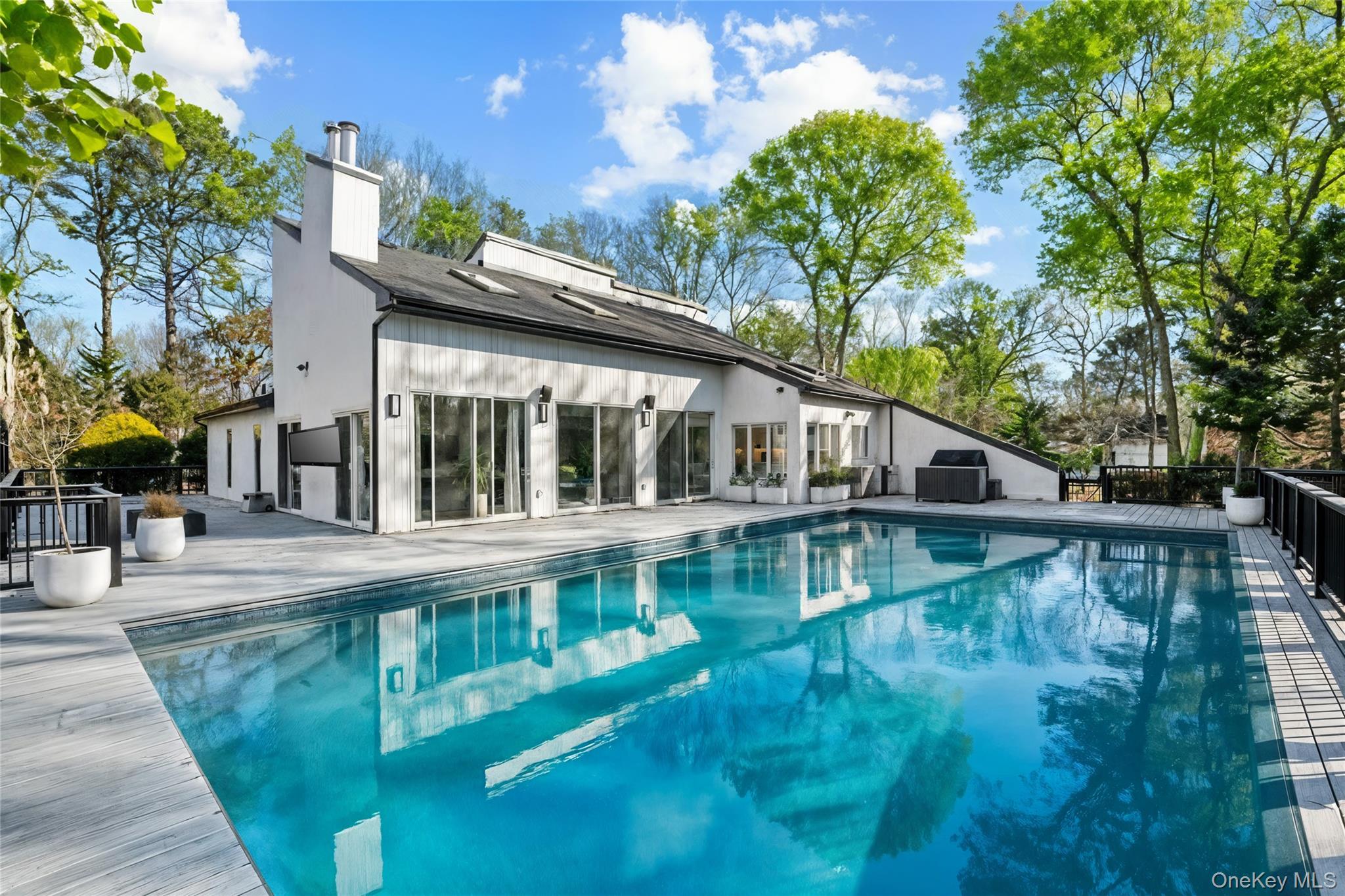 7 Midhampton Court Quogue, NY 11959 - Photo 4 of 29 a view of a house with pool and sitting area