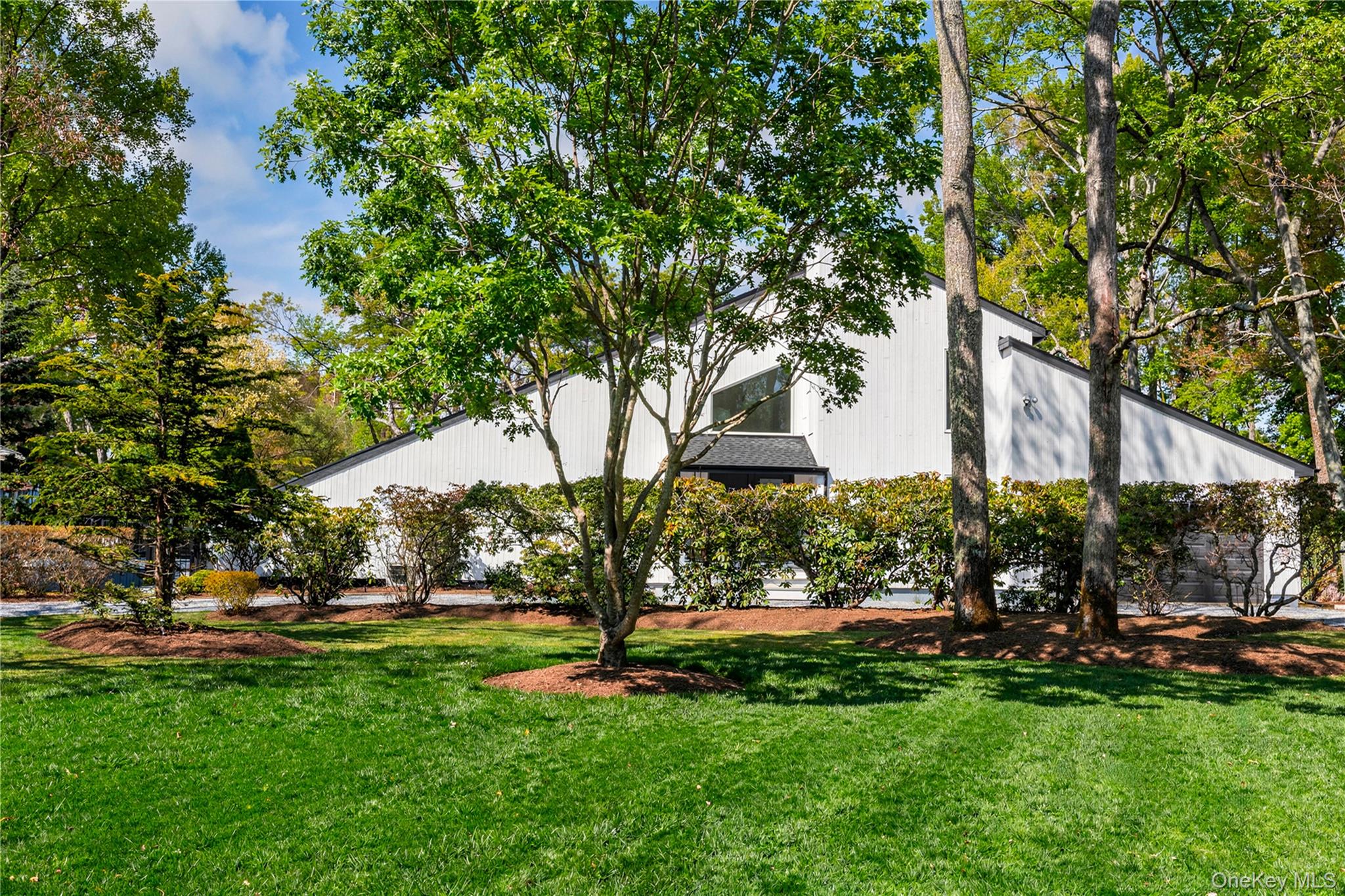 7 Midhampton Court Quogue, NY 11959 - Photo 6 of 29 a view of outdoor space with garden and trees