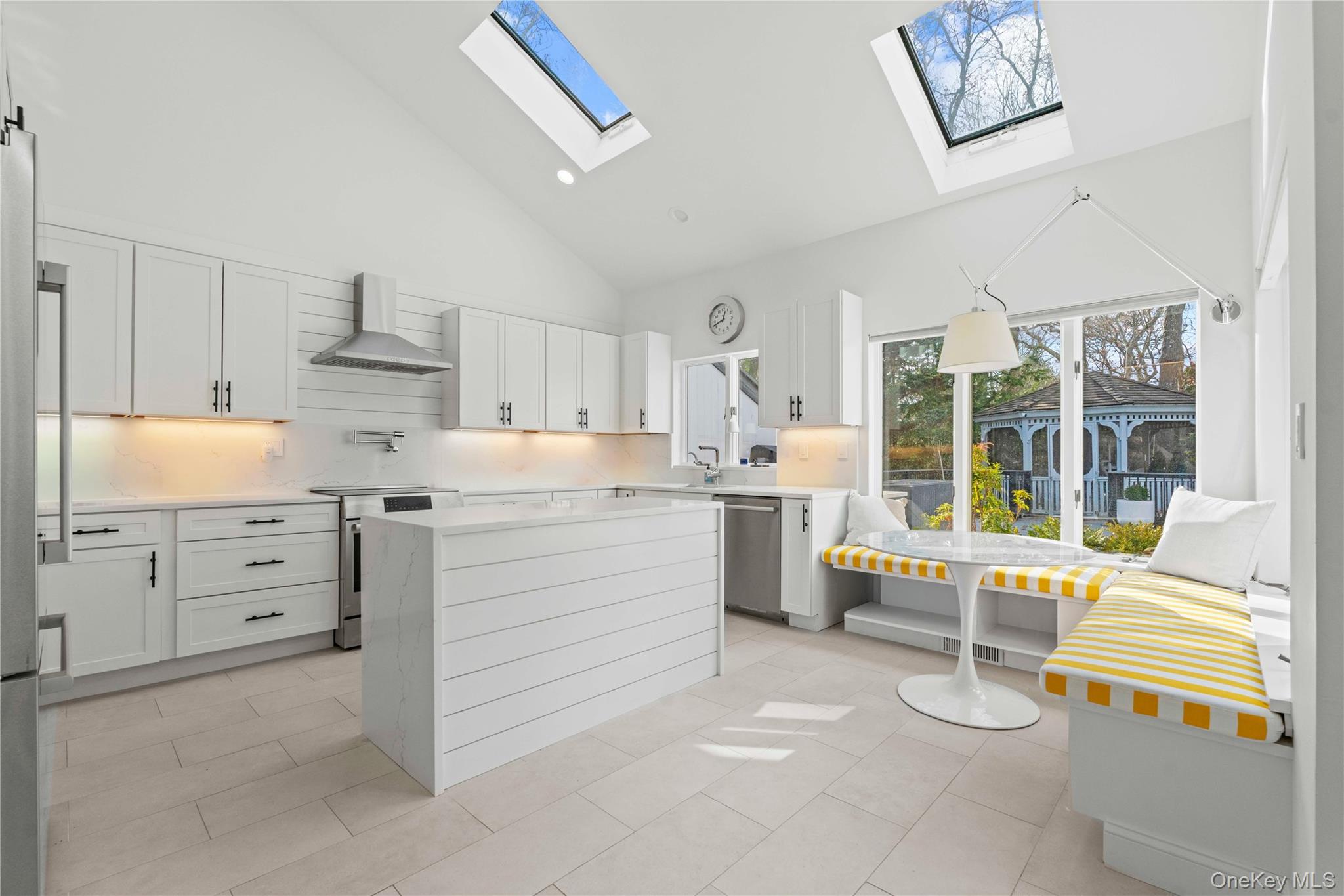 7 Midhampton Court Quogue, NY 11959 - Photo 7 of 24 a kitchen with granite countertop cabinets and appliances