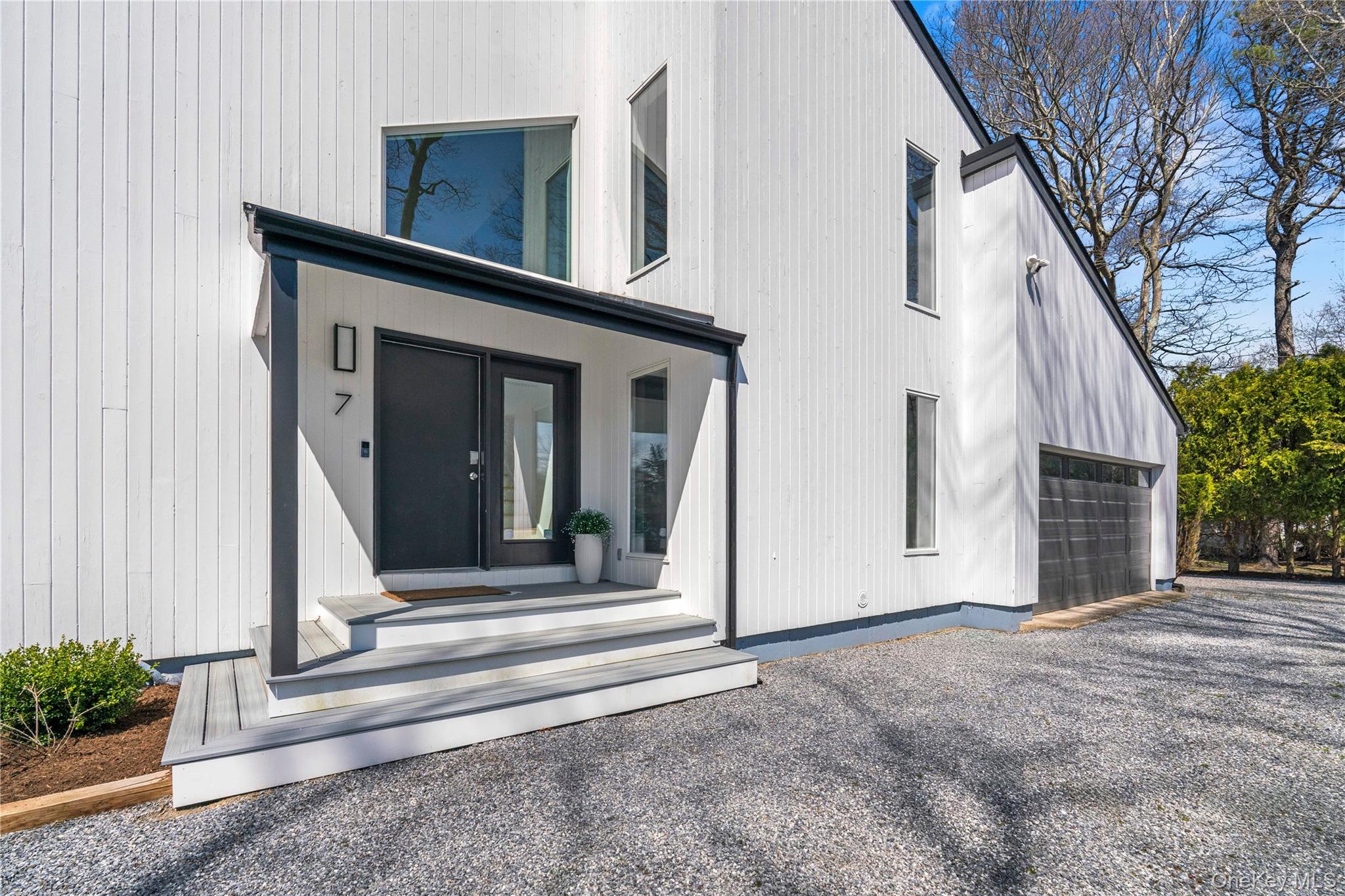 7 Midhampton Court Quogue, NY 11959 - Photo 8 of 29 a view of a house with a door and stairs