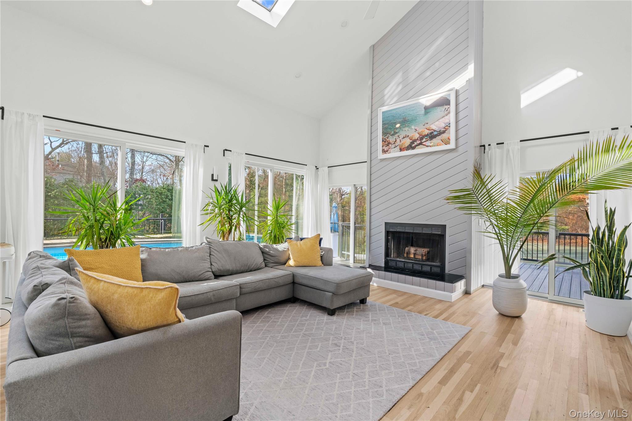 7 Midhampton Court Quogue, NY 11959 - Photo 8 of 24 a living room with furniture and a fireplace