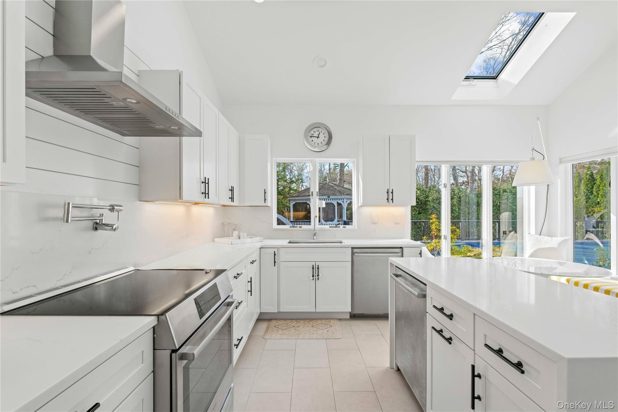 7 Midhampton Court Quogue, NY 11959 - Photo 9 of 24 a kitchen with a sink stove and cabinets