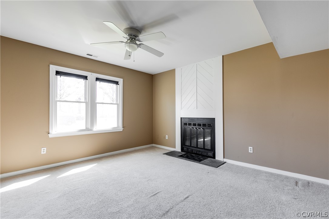 5212 South Jessup Road Chesterfield, VA 23832 - Photo 15 of 25 an empty room with chandelier fan and windows