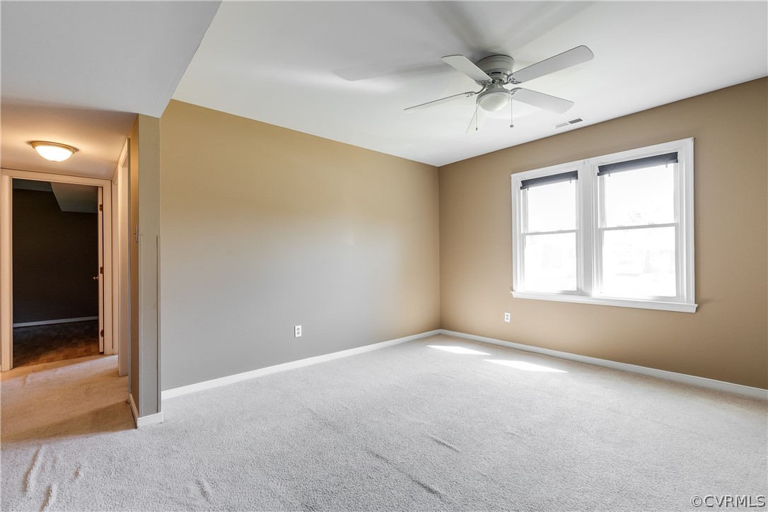 5212 South Jessup Road Chesterfield, VA 23832 - Photo 16 of 25 an empty room with a ceiling fan and window