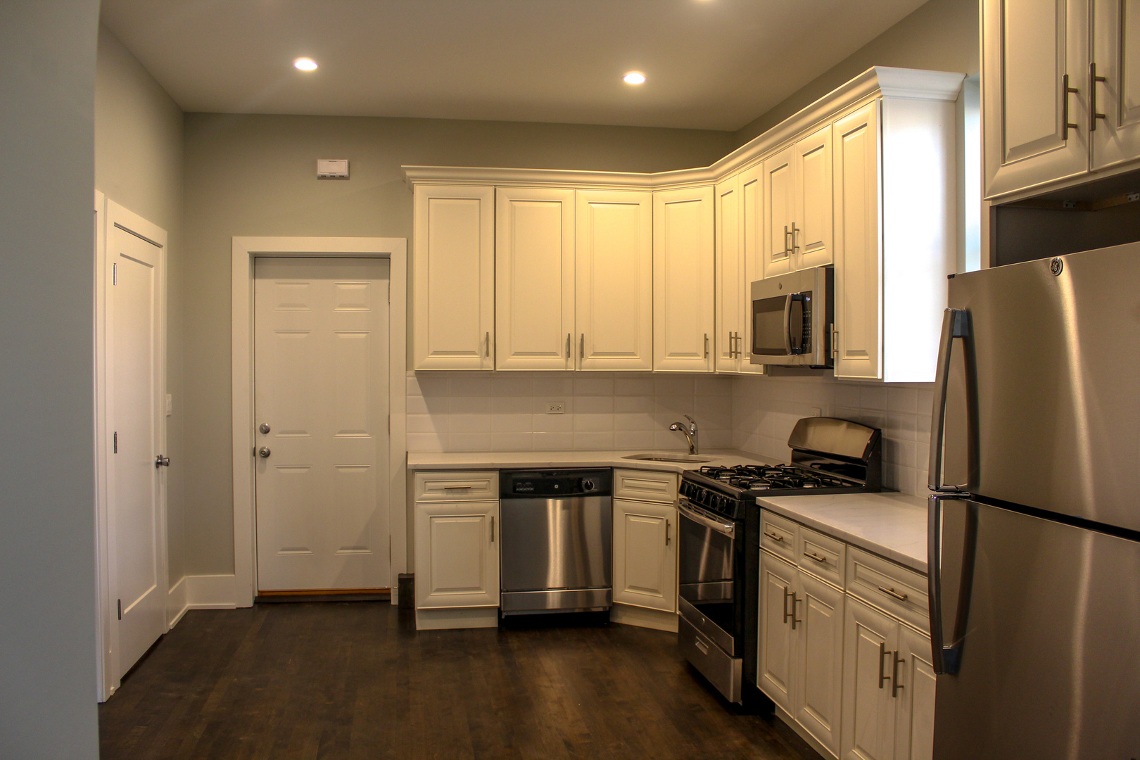 1701 West Nelson Street, Unit 1F Chicago, IL 60657 - Photo 2 of 10 a kitchen with a refrigerator stove and microwave