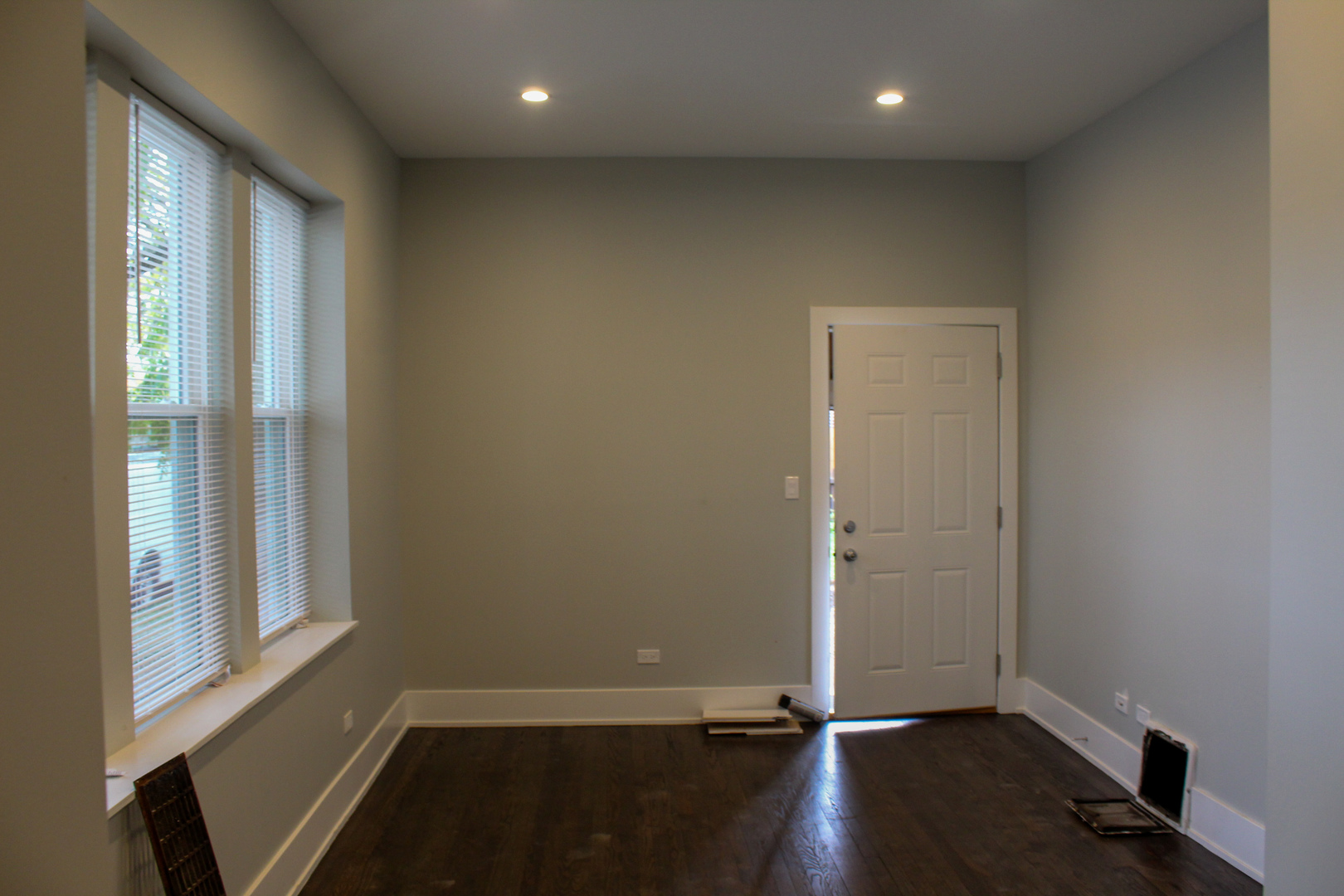 1701 West Nelson Street, Unit 1F Chicago, IL 60657 - Photo 5 of 10 an empty room with wooden floor and windows