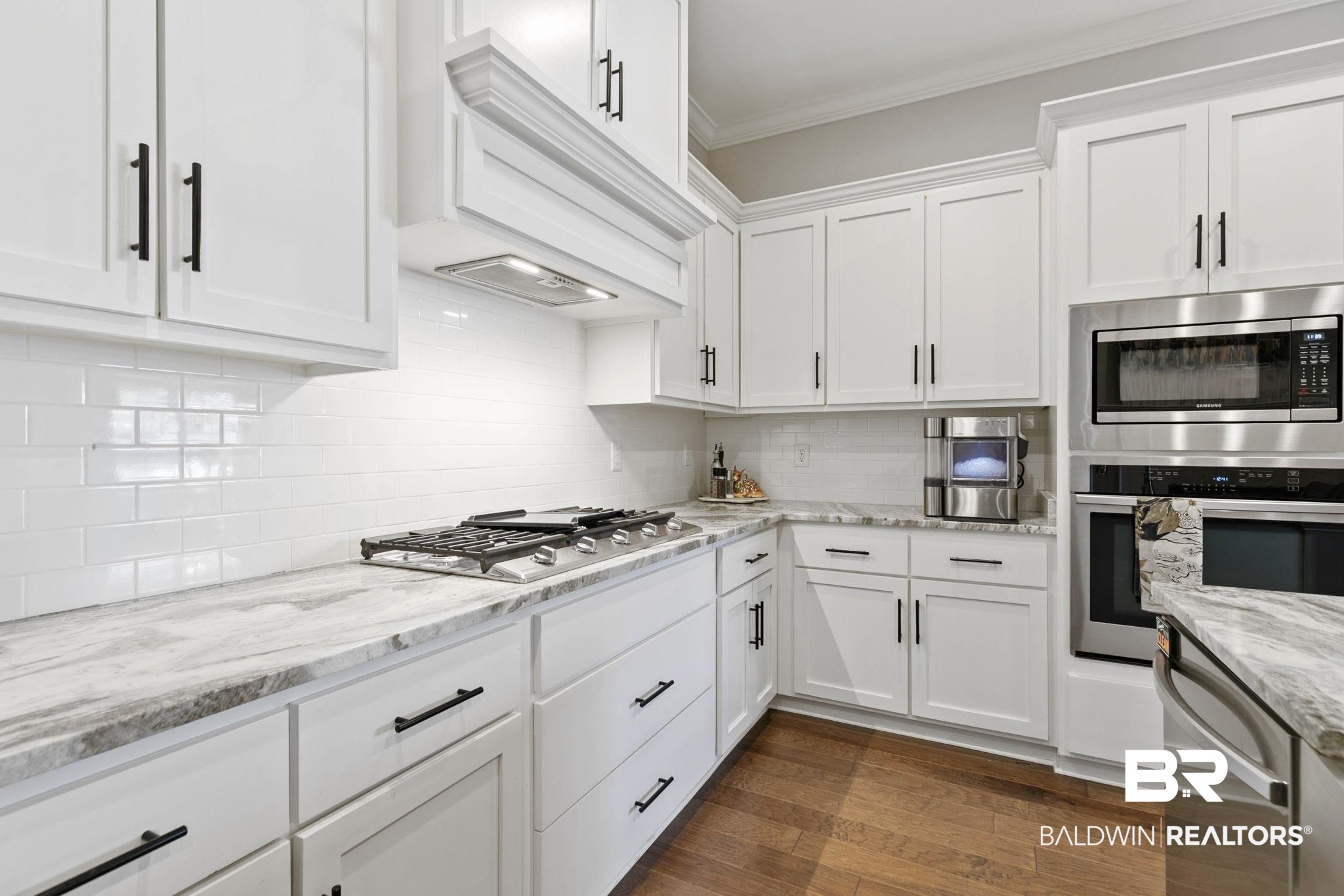 291 Hemlock Drive Fairhope, AL 36532 - Photo 15 of 65 Kitchen with white cabinetry, stainless steel appliances, light stone counters, and crown molding