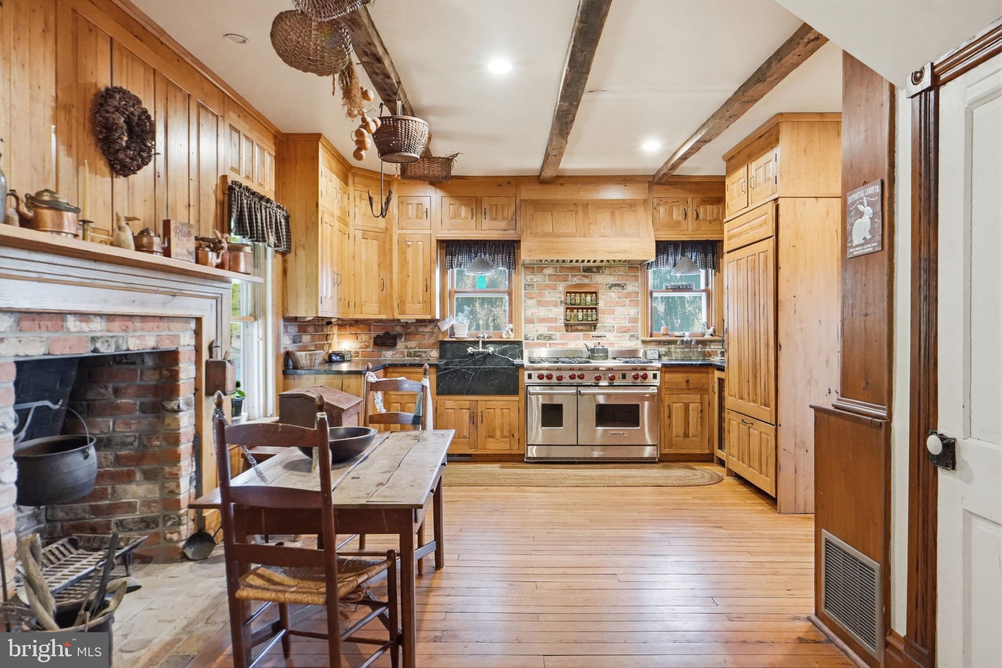 13405 John Kline Road Smithsburg, MD 21783 - Photo 11 of 96 a kitchen with stainless steel appliances a stove top oven a sink a dining table and chairs