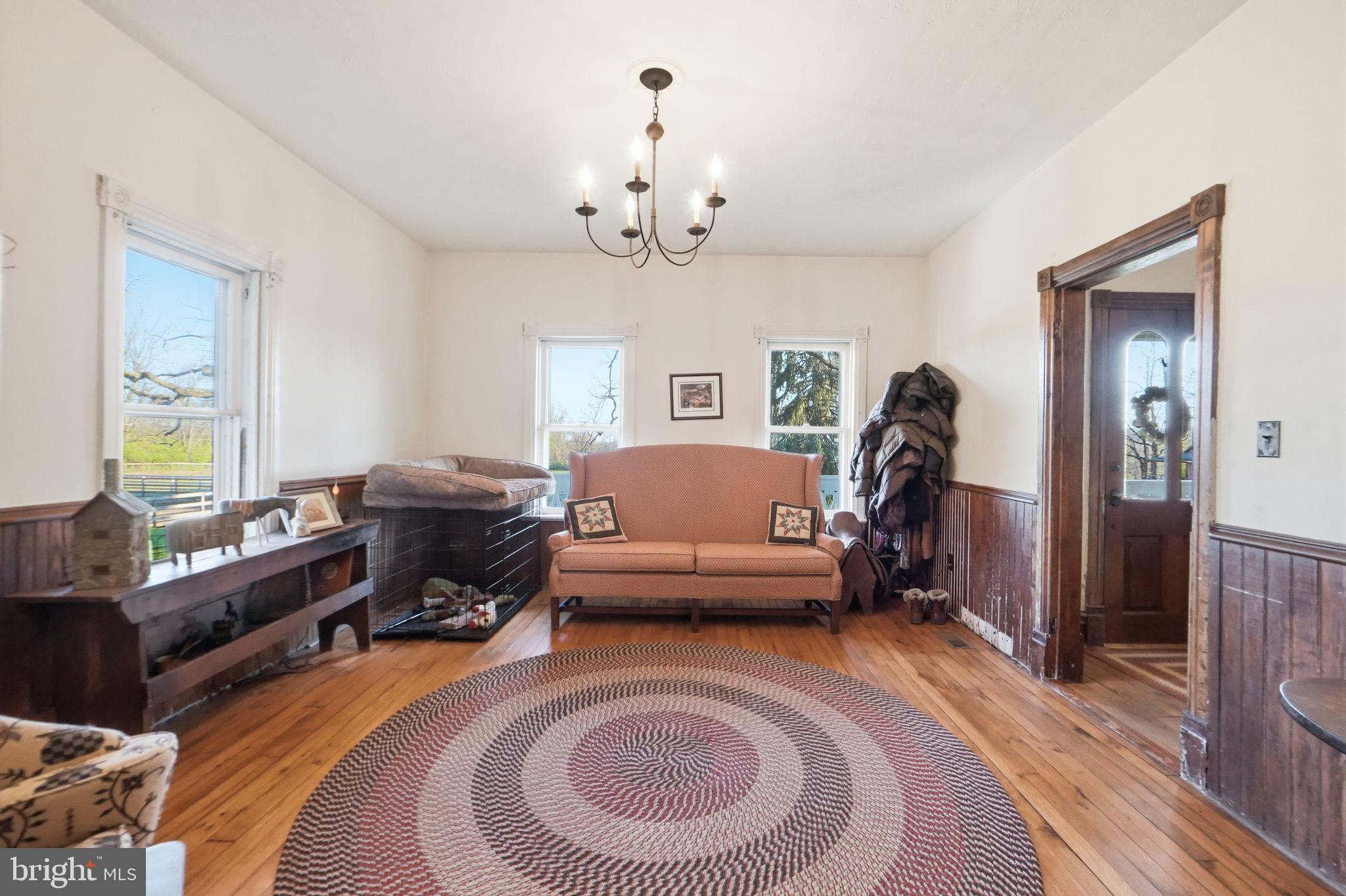13405 John Kline Road Smithsburg, MD 21783 - Photo 18 of 96 a living room with furniture a couch and a chandelier