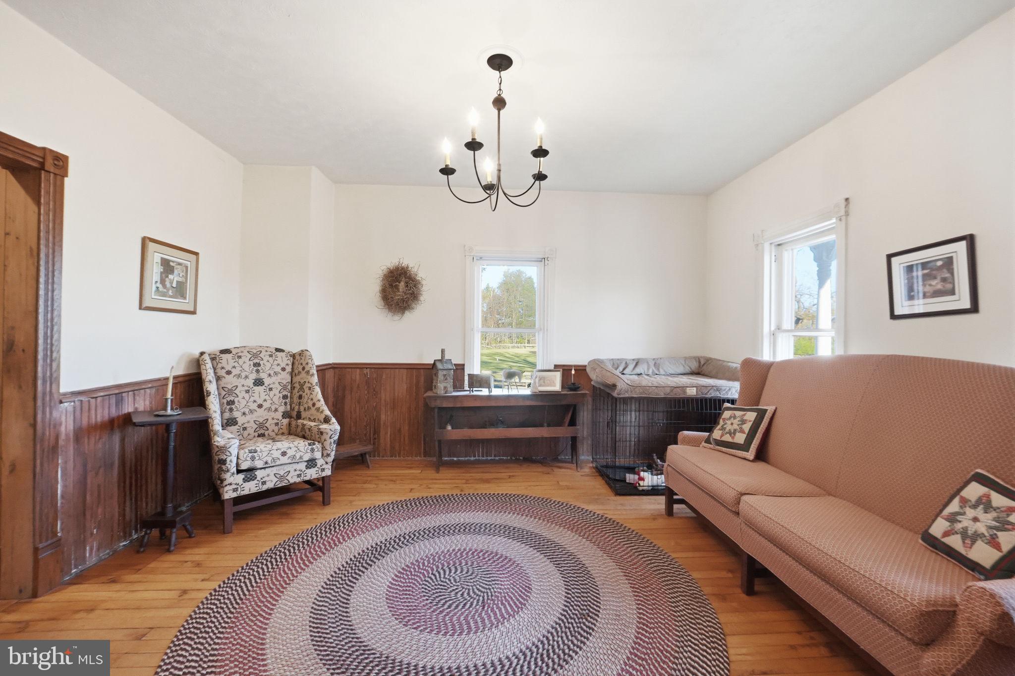 13405 John Kline Road Smithsburg, MD 21783 - Photo 19 of 96 a living room with furniture and a chandelier