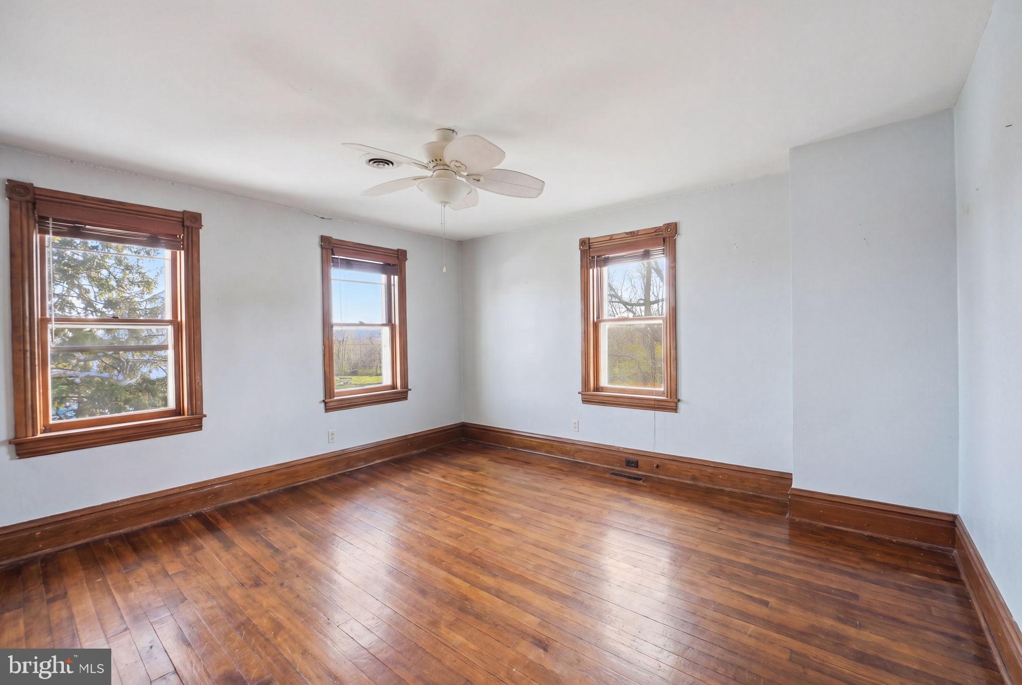 13405 John Kline Road Smithsburg, MD 21783 - Photo 27 of 96 a view of an empty room with wooden floor and a window