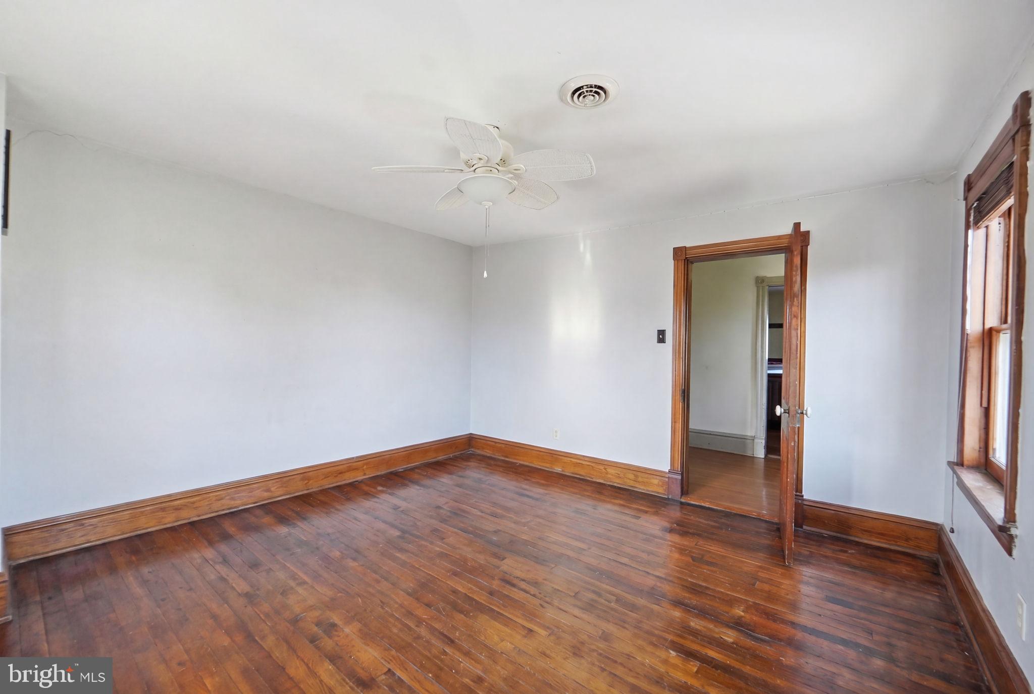 13405 John Kline Road Smithsburg, MD 21783 - Photo 28 of 96 a view of empty room with wooden floor and fan