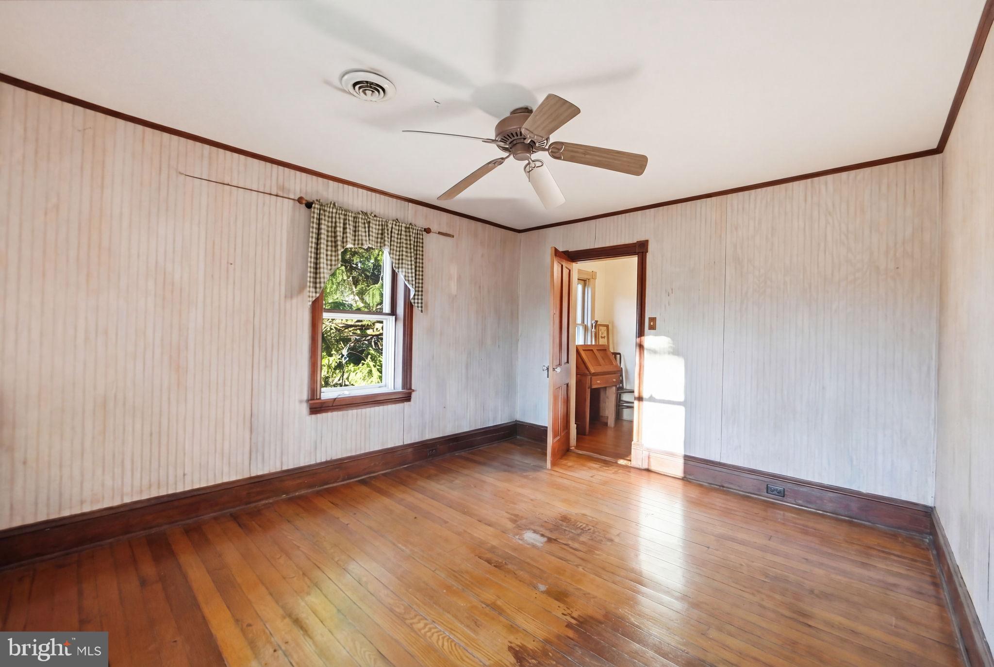 13405 John Kline Road Smithsburg, MD 21783 - Photo 31 of 96 a view of empty room with wooden floor and fan