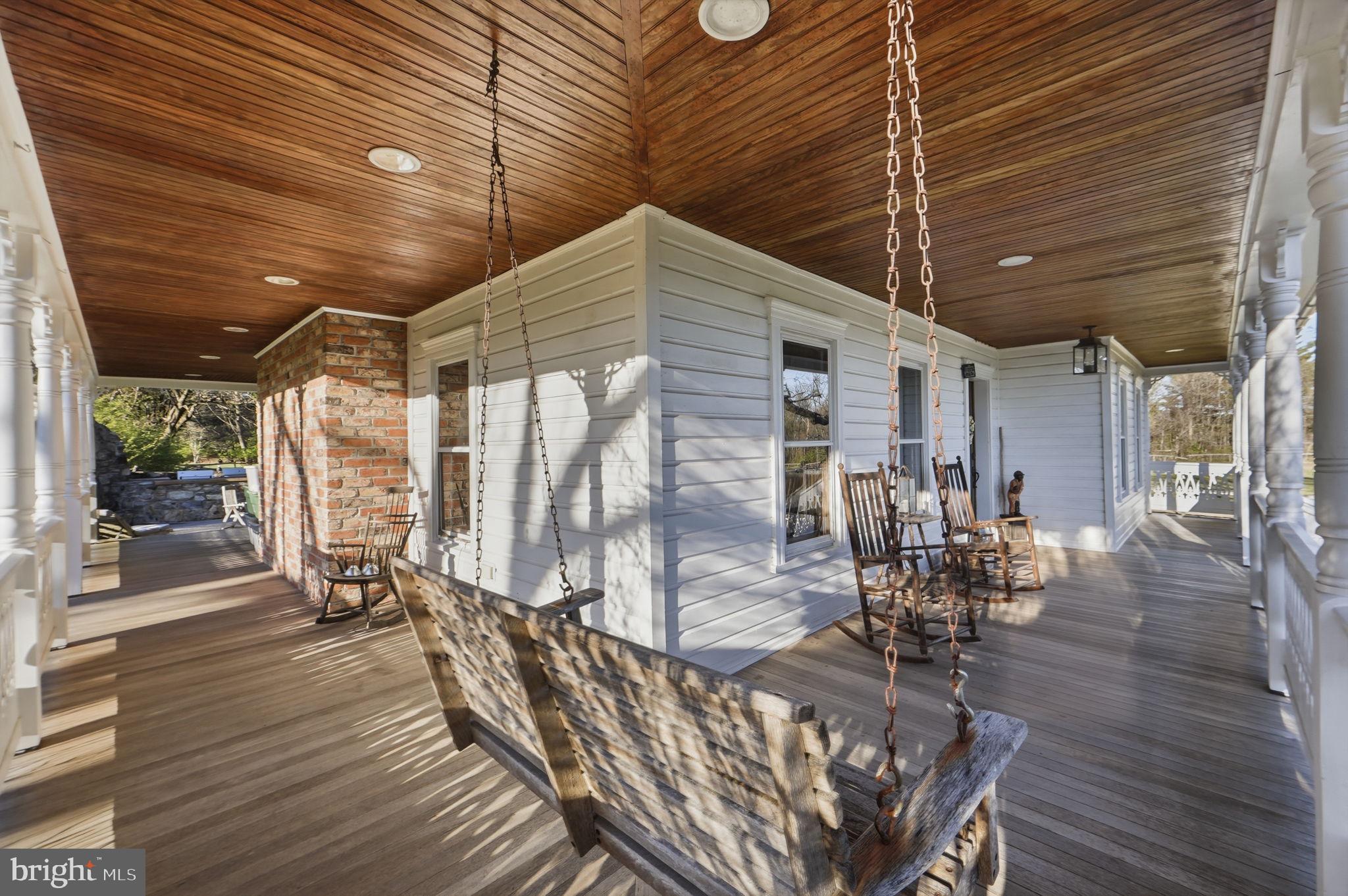 13405 John Kline Road Smithsburg, MD 21783 - Photo 66 of 96 a view of a patio with table and chairs potted plants with wooden floor
