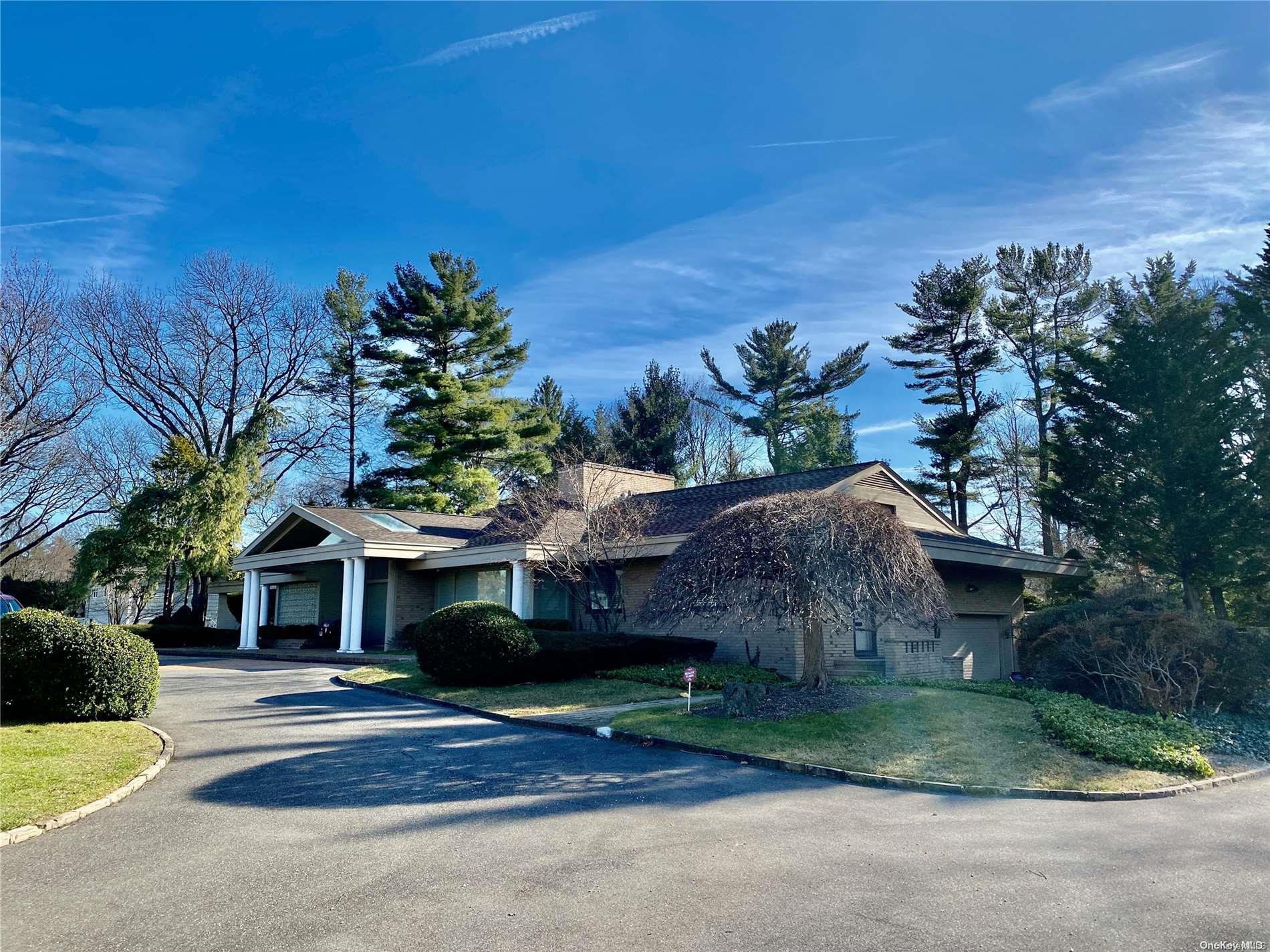 49 Remsen Road Great Neck, NY 11024 - Photo 1 of 1 a front view of a house with a yard and garage