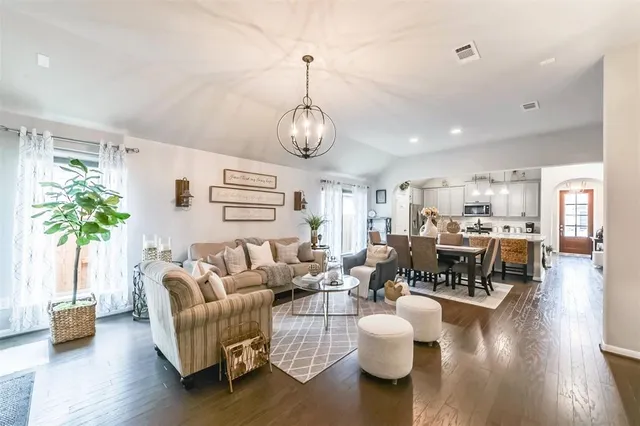 a living room with fireplace furniture and a wooden floor