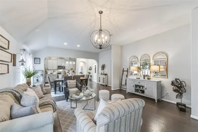 a living room with furniture chandelier and a view of living room