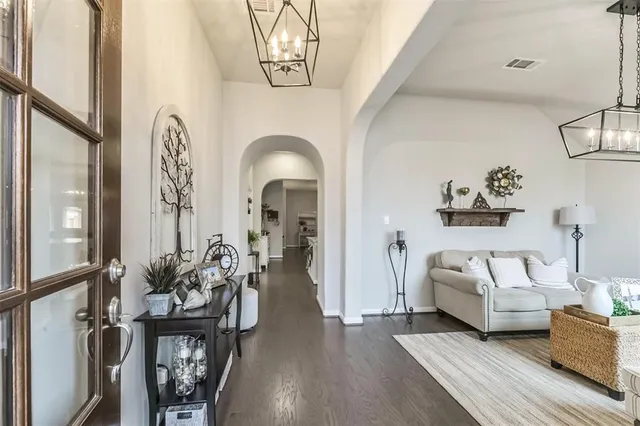 a living room with furniture a couch and wooden floor