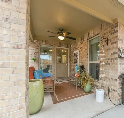 a living room with furniture a chandelier and a dining table
