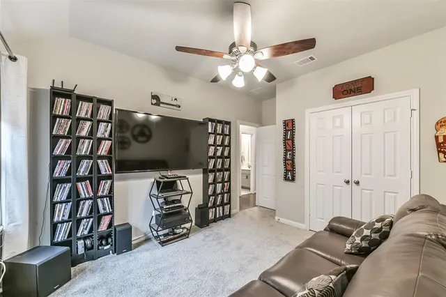 a view of a livingroom with furniture and a bookshelf