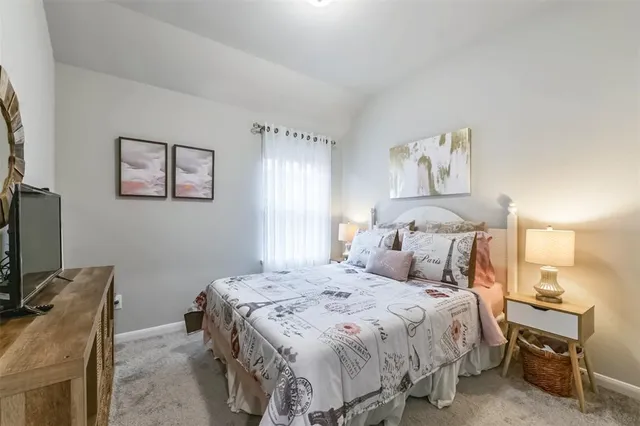 a bedroom with a bed and a desk