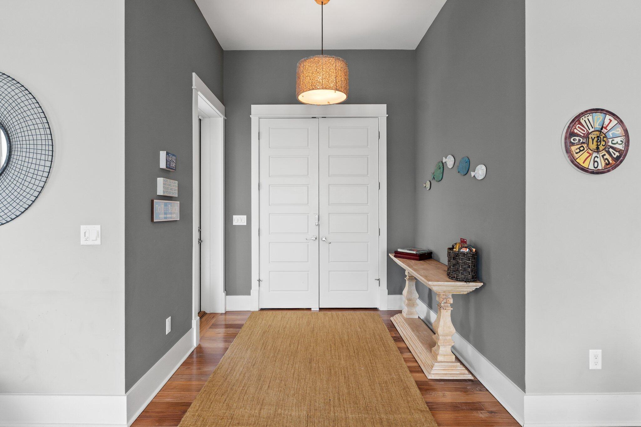 104 Pinwheel Court Port St. Joe, FL 32456 - Photo 11 of 119 a view of a hallway with wooden floor and a bathroom