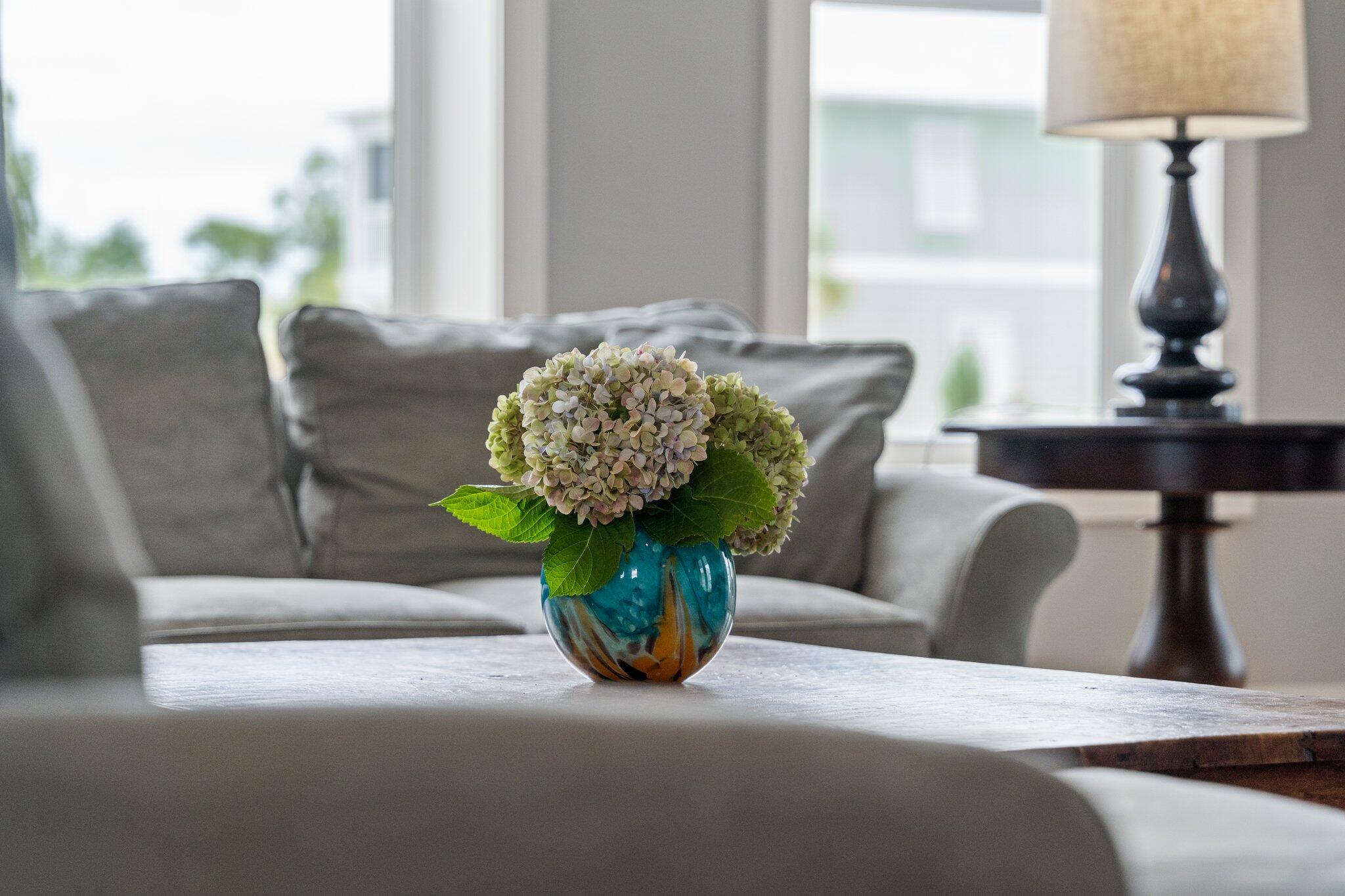 104 Pinwheel Court Port St. Joe, FL 32456 - Photo 14 of 119 a view of a dining room with furniture a potted plant and wooden floor