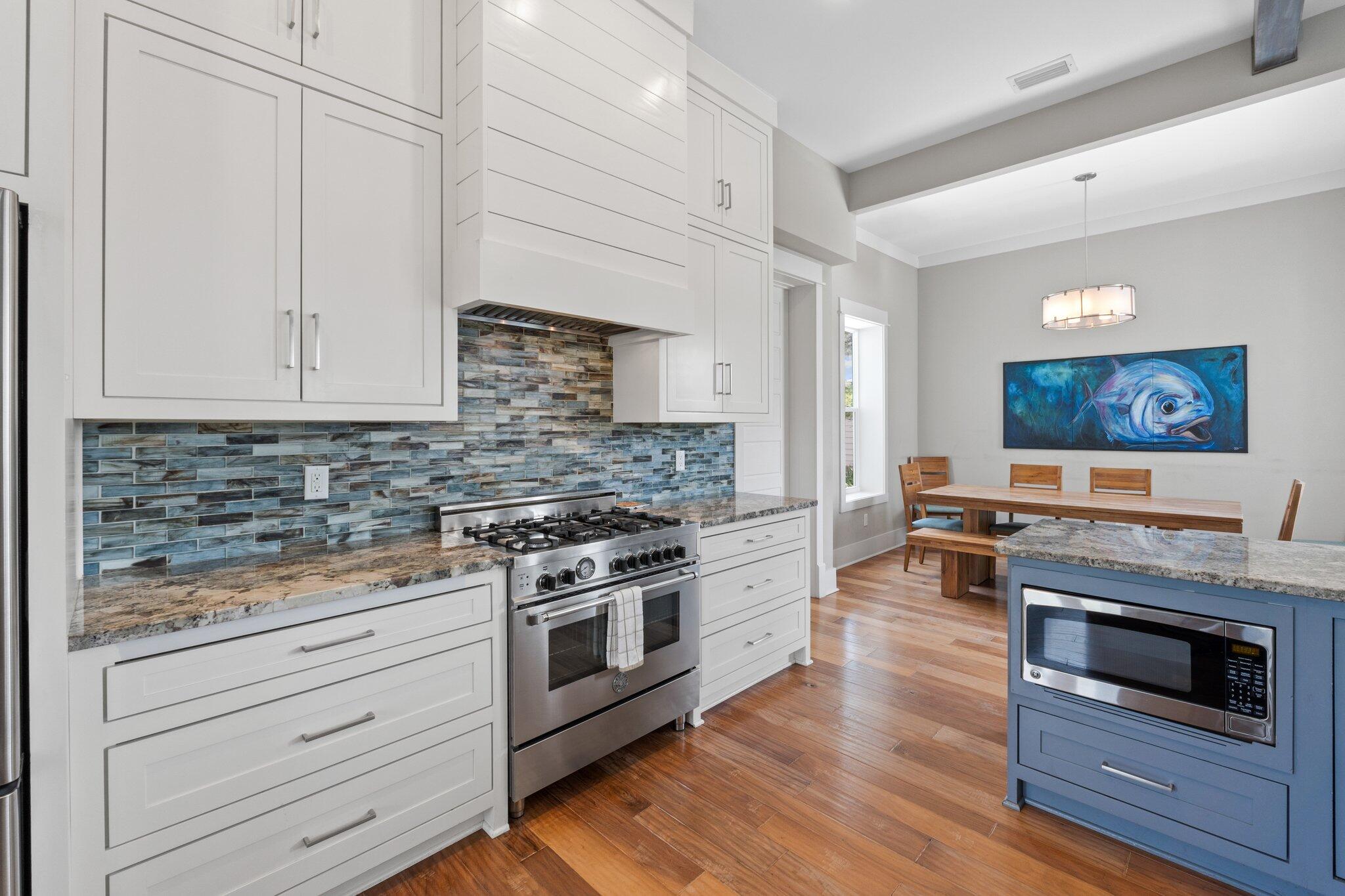 104 Pinwheel Court Port St. Joe, FL 32456 - Photo 25 of 119 a kitchen with stainless steel appliances wooden floor and a stove top oven