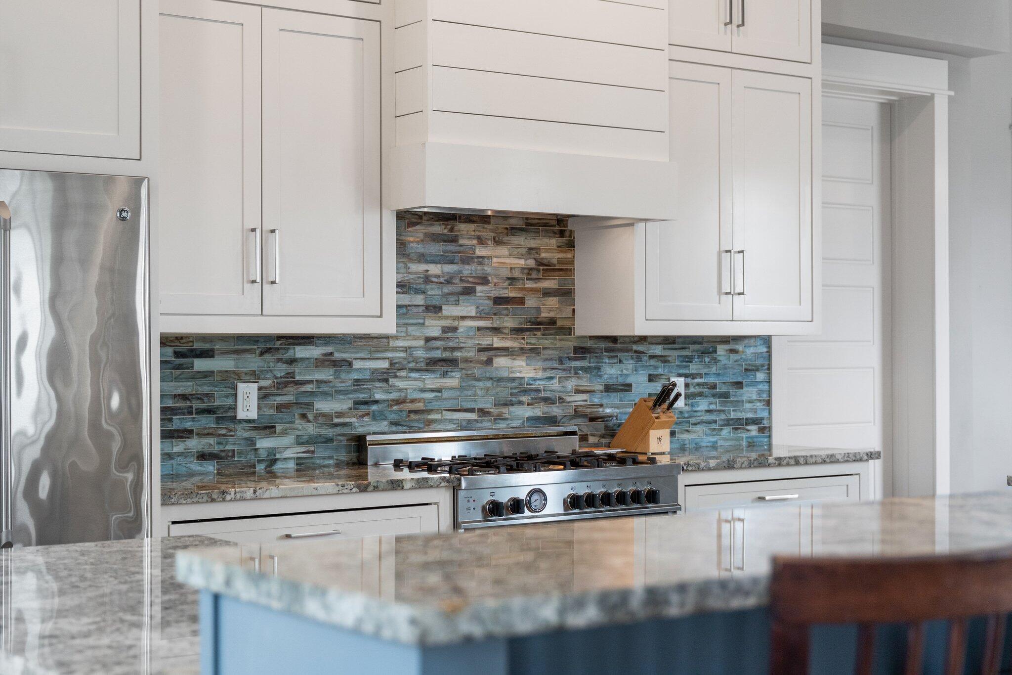 104 Pinwheel Court Port St. Joe, FL 32456 - Photo 26 of 119 a kitchen with stainless steel appliances granite countertop a stove and a white cabinets