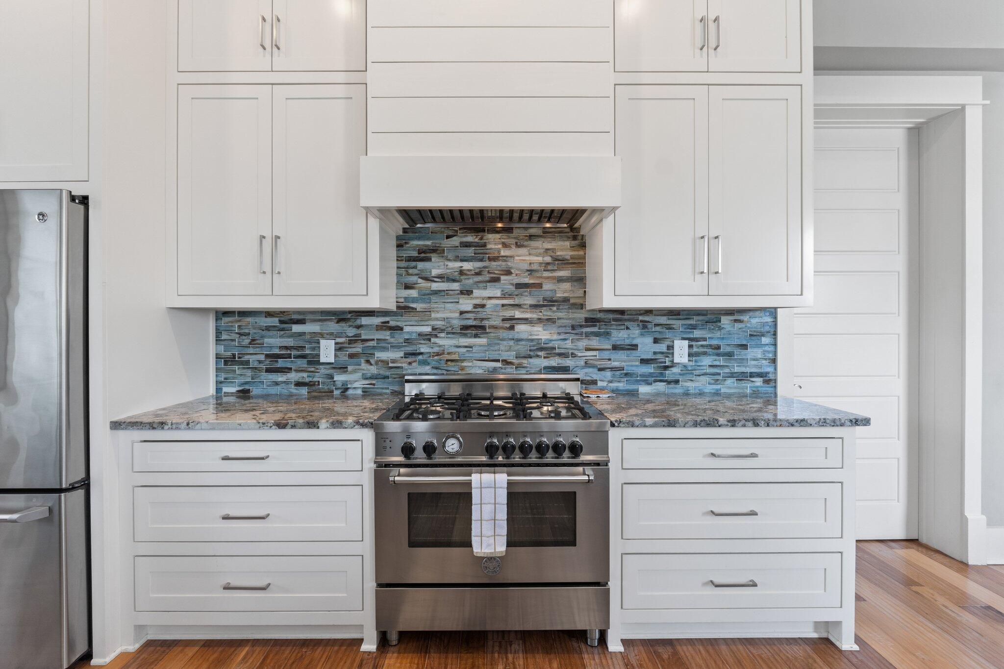 104 Pinwheel Court Port St. Joe, FL 32456 - Photo 28 of 119 a kitchen with granite countertop white cabinets and white appliances