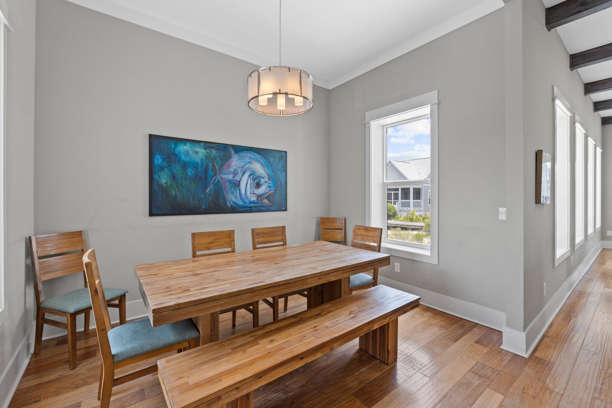 104 Pinwheel Court Port St. Joe, FL 32456 - Photo 31 of 119 a view of a dining room with furniture wooden floor and a chandelier