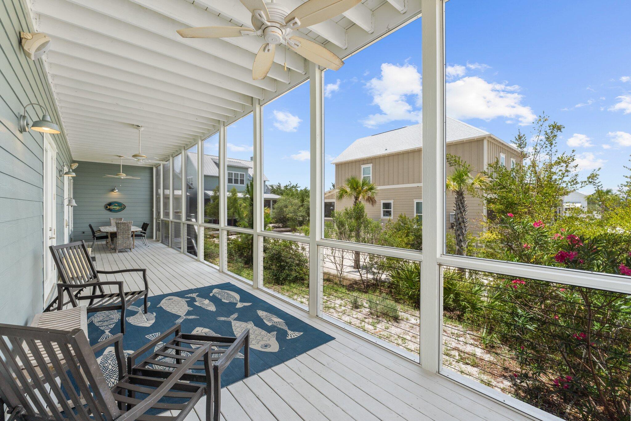 104 Pinwheel Court Port St. Joe, FL 32456 - Photo 35 of 119 a view of a patio with table and chairs and wooden floor