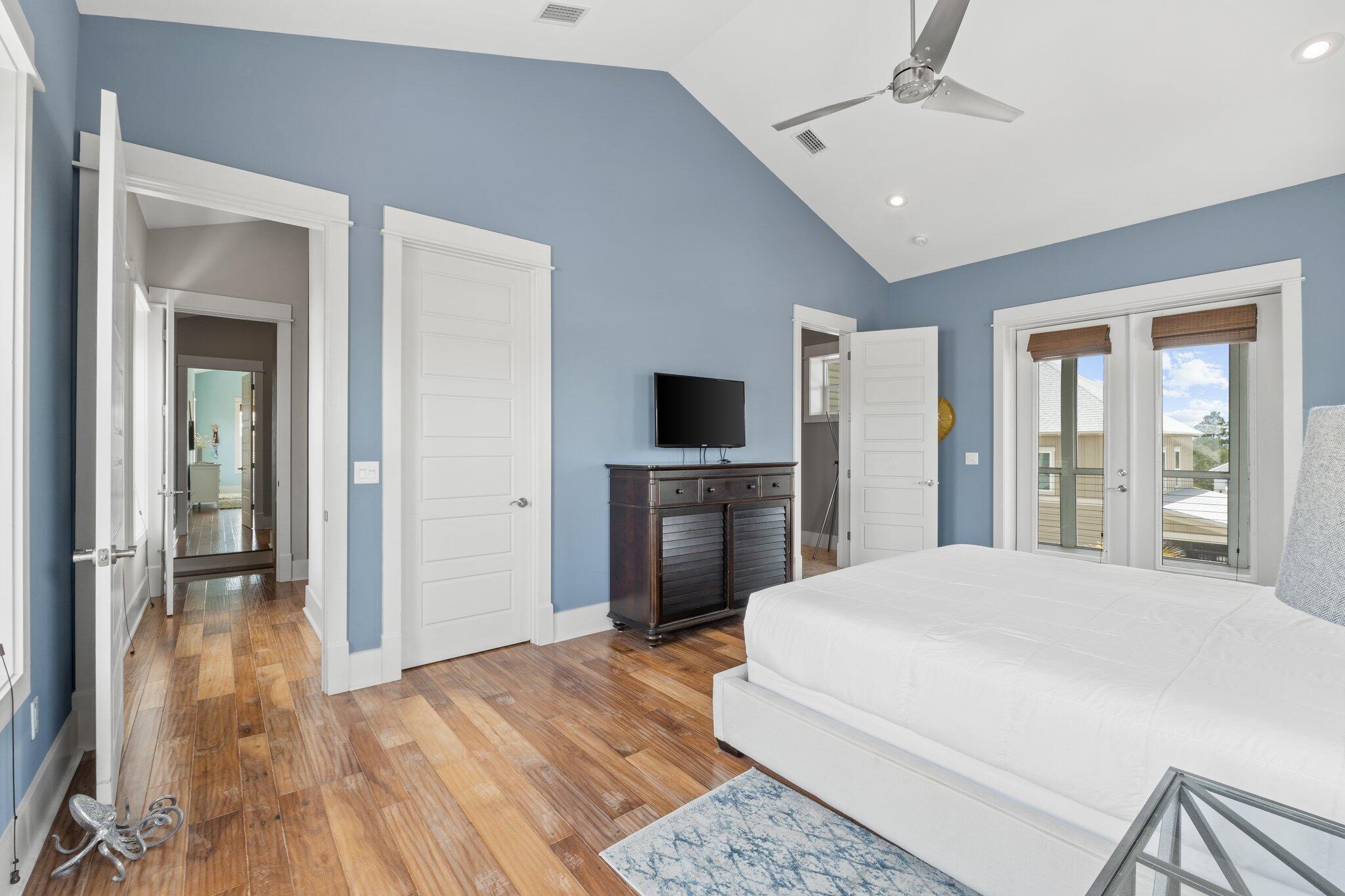 104 Pinwheel Court Port St. Joe, FL 32456 - Photo 45 of 119 a large bedroom with a bed and a flat screen tv