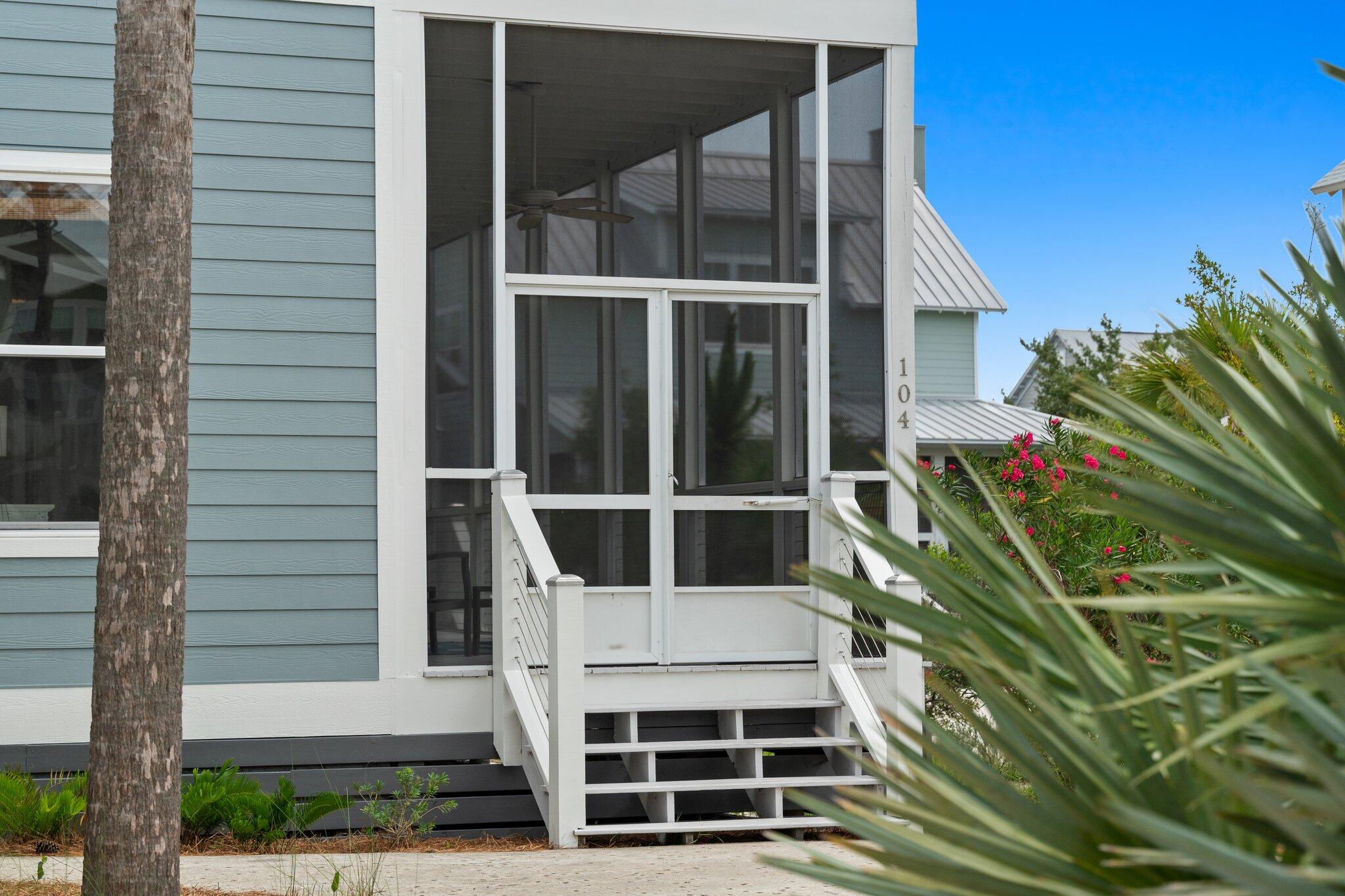 104 Pinwheel Court Port St. Joe, FL 32456 - Photo 5 of 119 a front view of a house with a garden