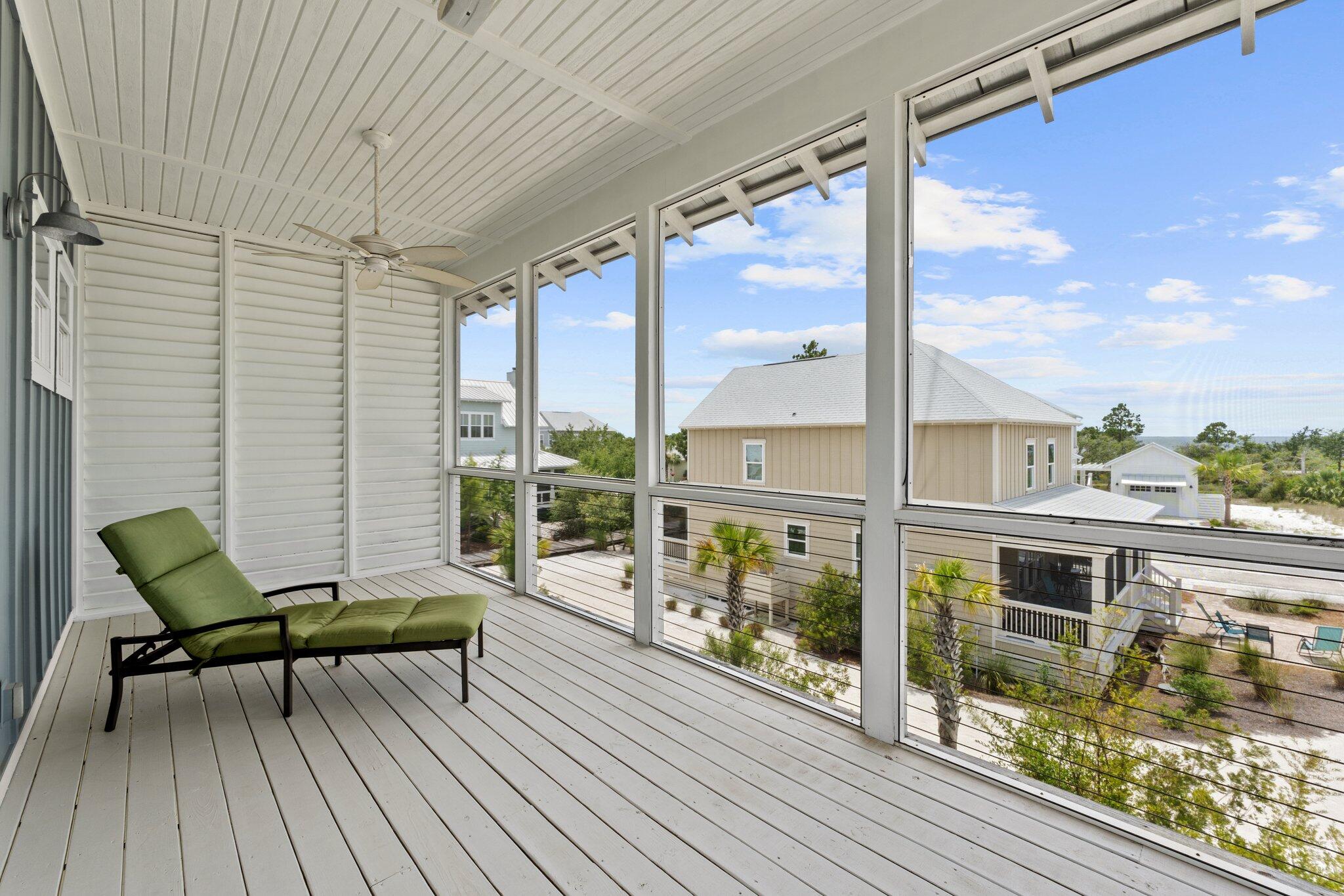 104 Pinwheel Court Port St. Joe, FL 32456 - Photo 54 of 119 a view of a balcony with furniture and wooden floor