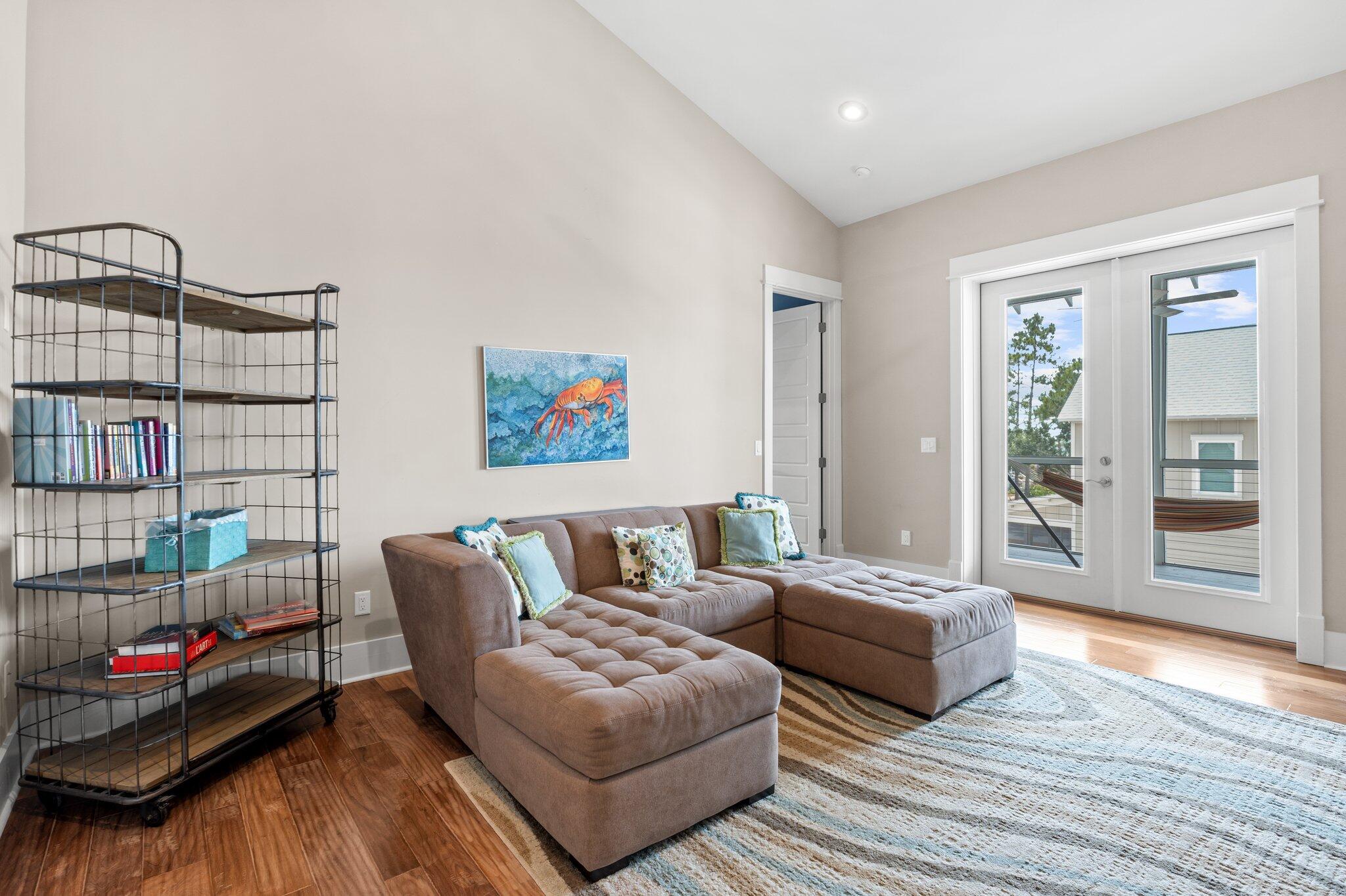 104 Pinwheel Court Port St. Joe, FL 32456 - Photo 70 of 119 a living room with furniture and a book shelf
