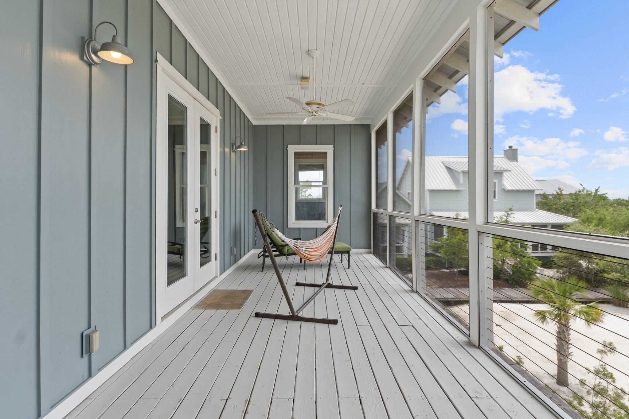 104 Pinwheel Court Port St. Joe, FL 32456 - Photo 83 of 119 a balcony view with a large window and wooden floor